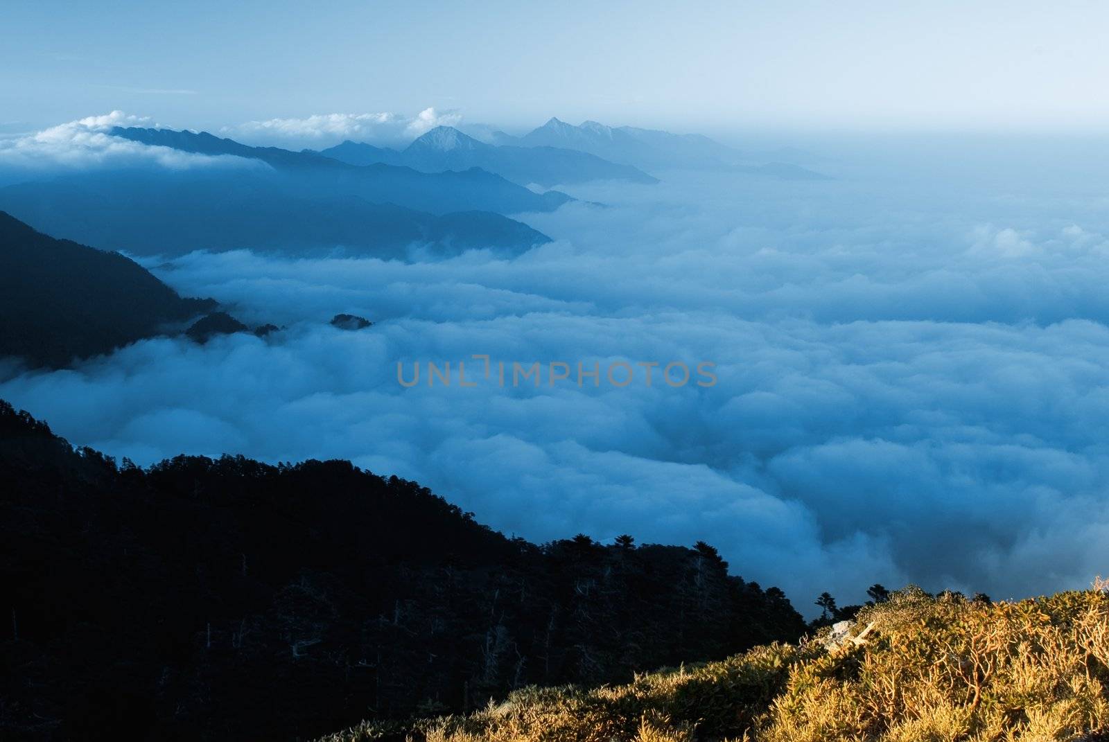 Clouds like sea and waterfall in high mountain.