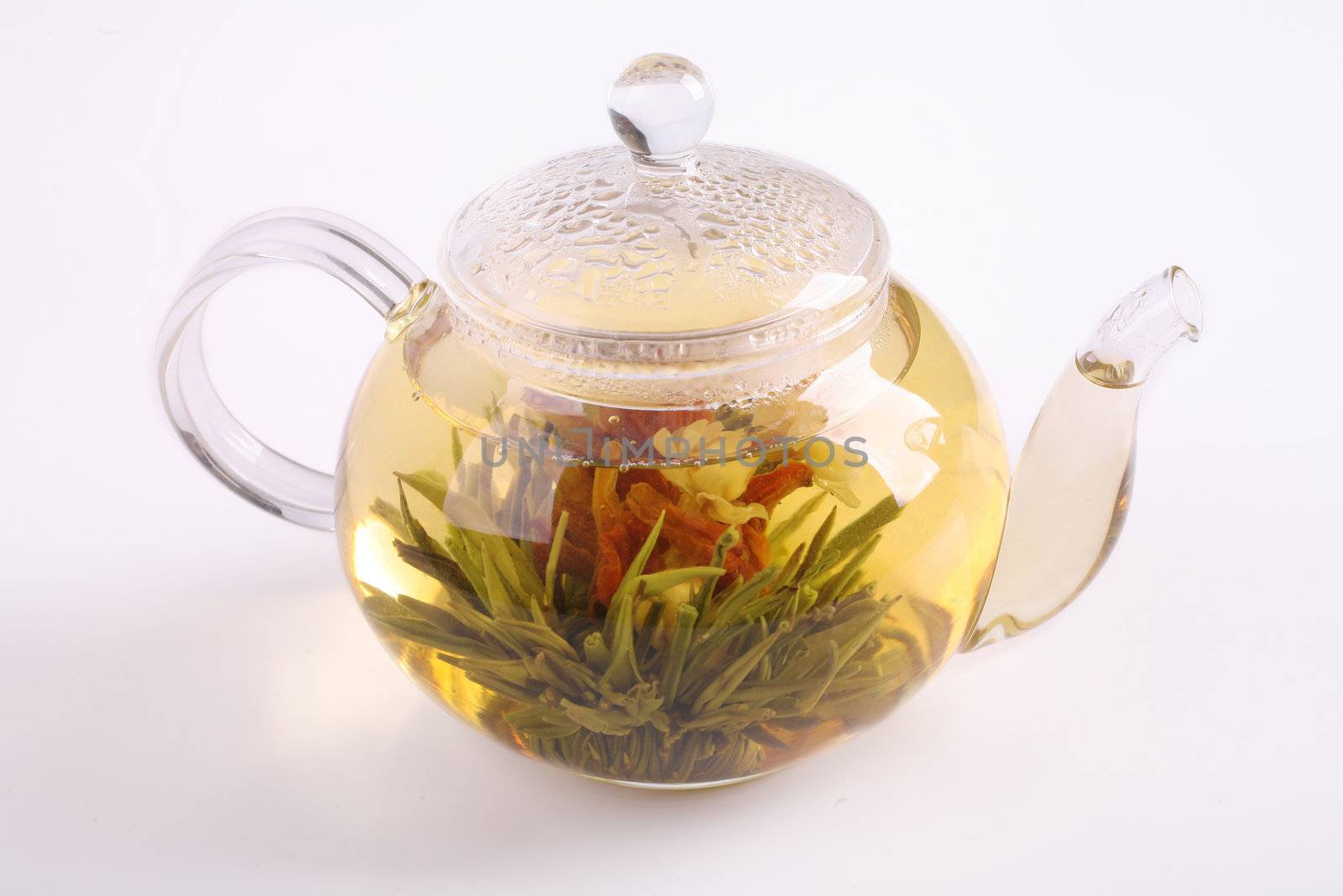 teapot with green tea on white background