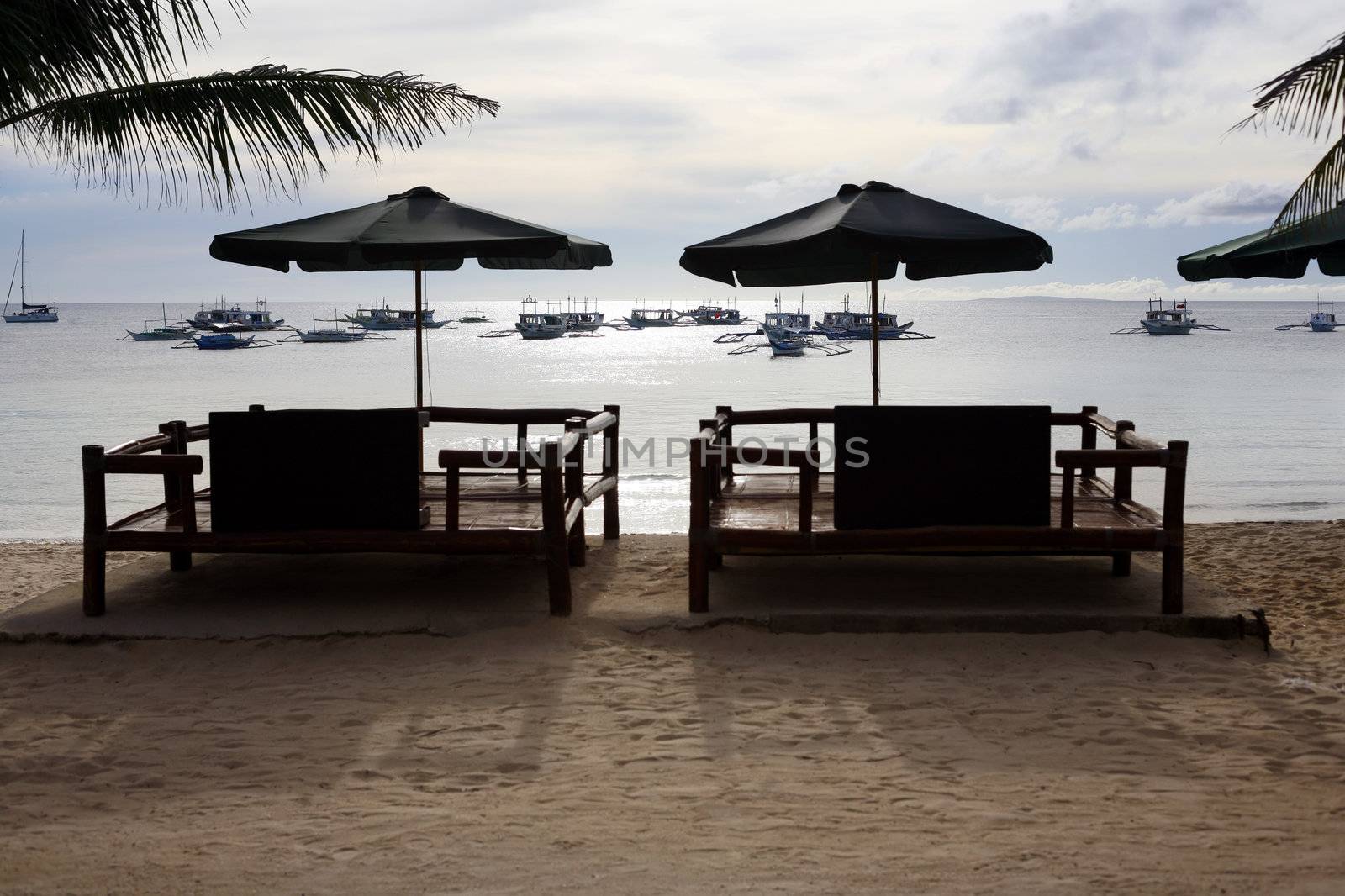 Armchairs for rest on a coast of silent ocean
