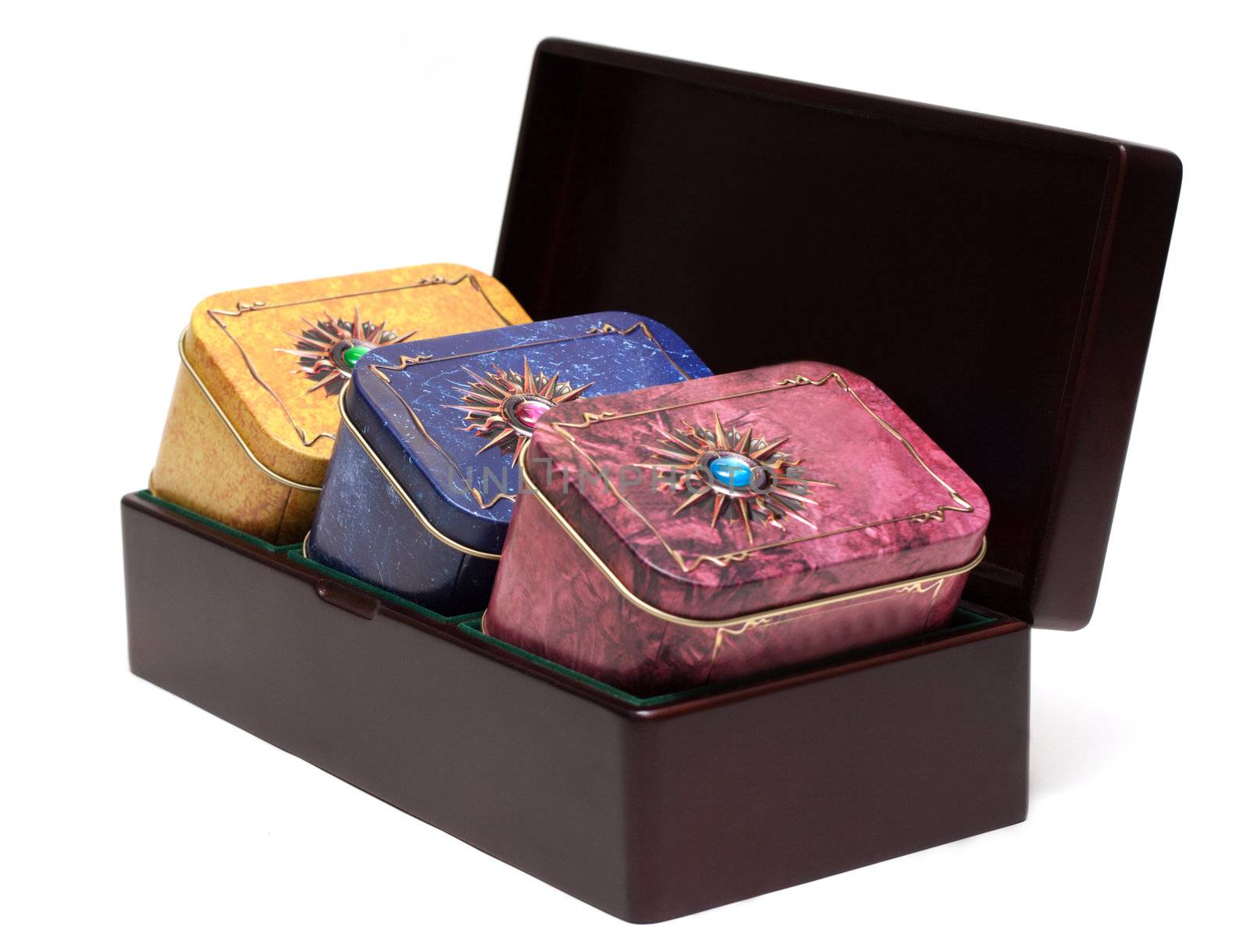 Box with tea, iron packing, decorated stone on white background