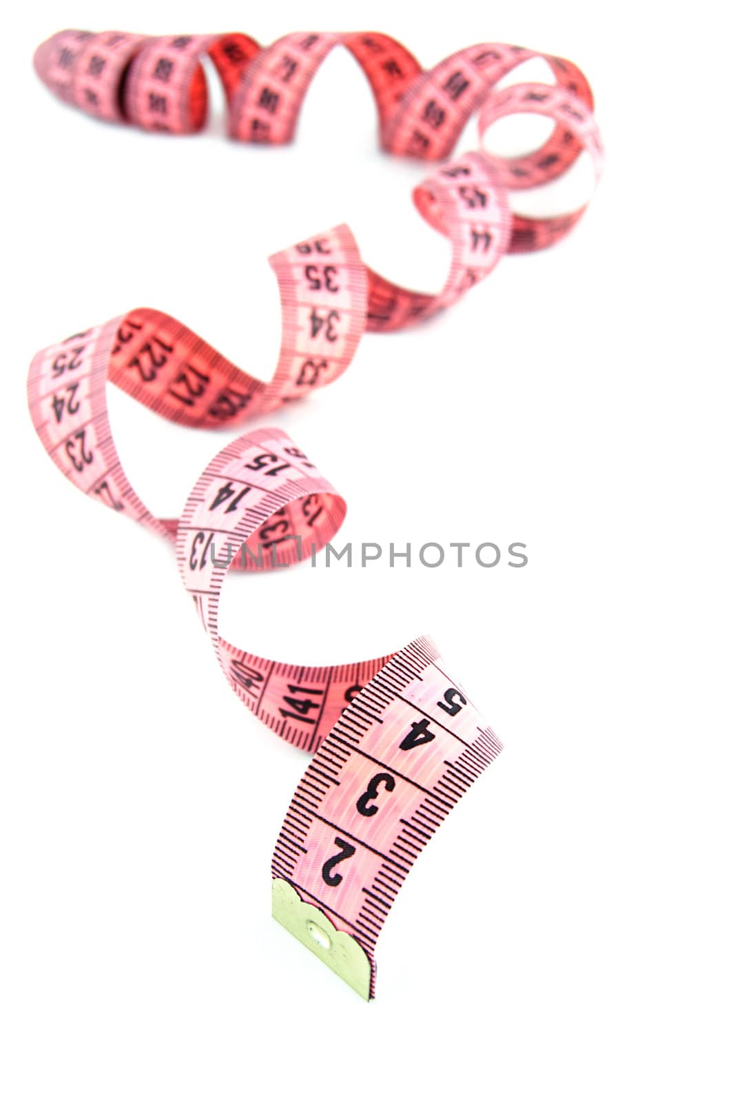 Pink measure tape rolled isolated on white