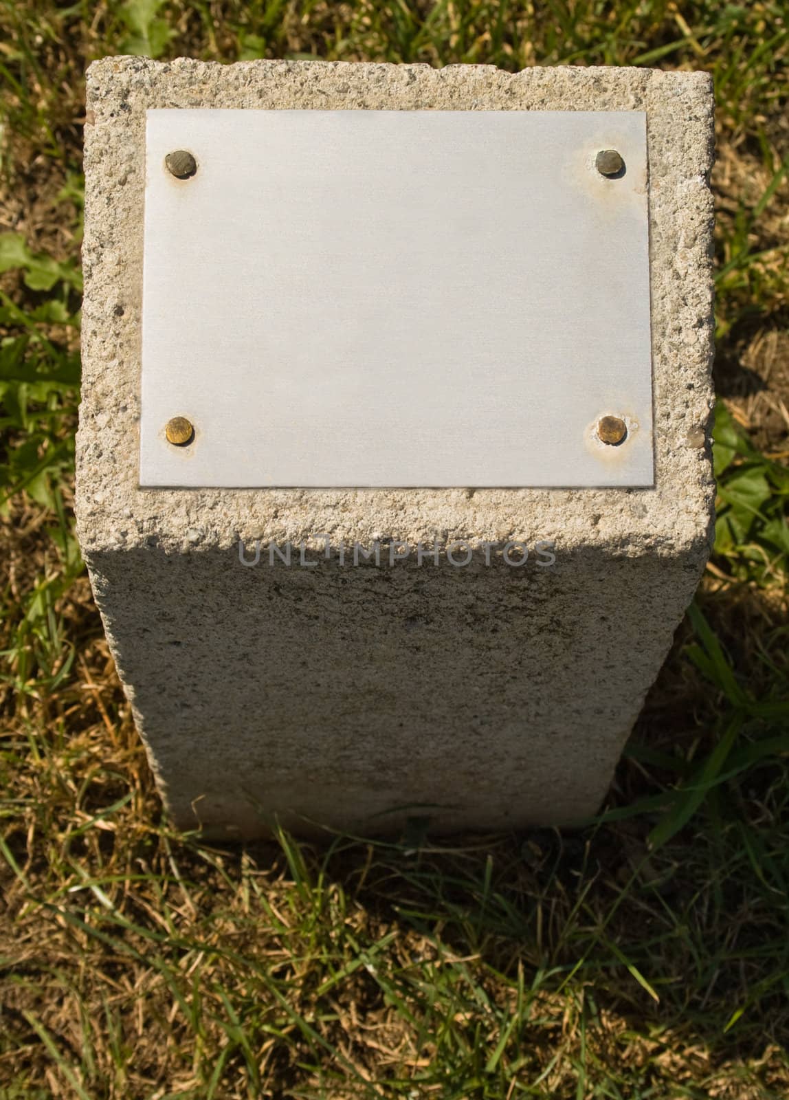 Concrete stone with a metal plate for an inscription 