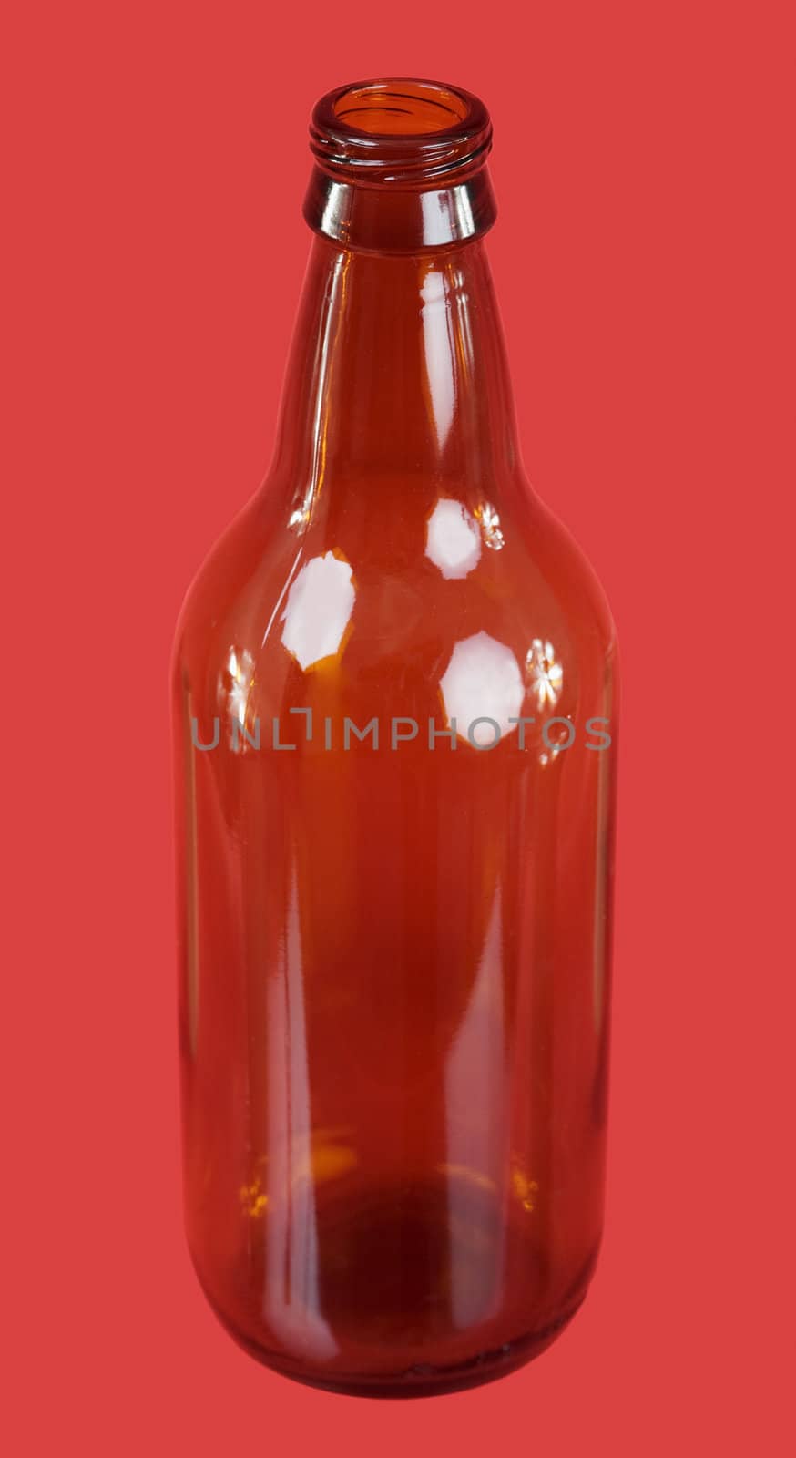 Brown glasses bottle on the red background