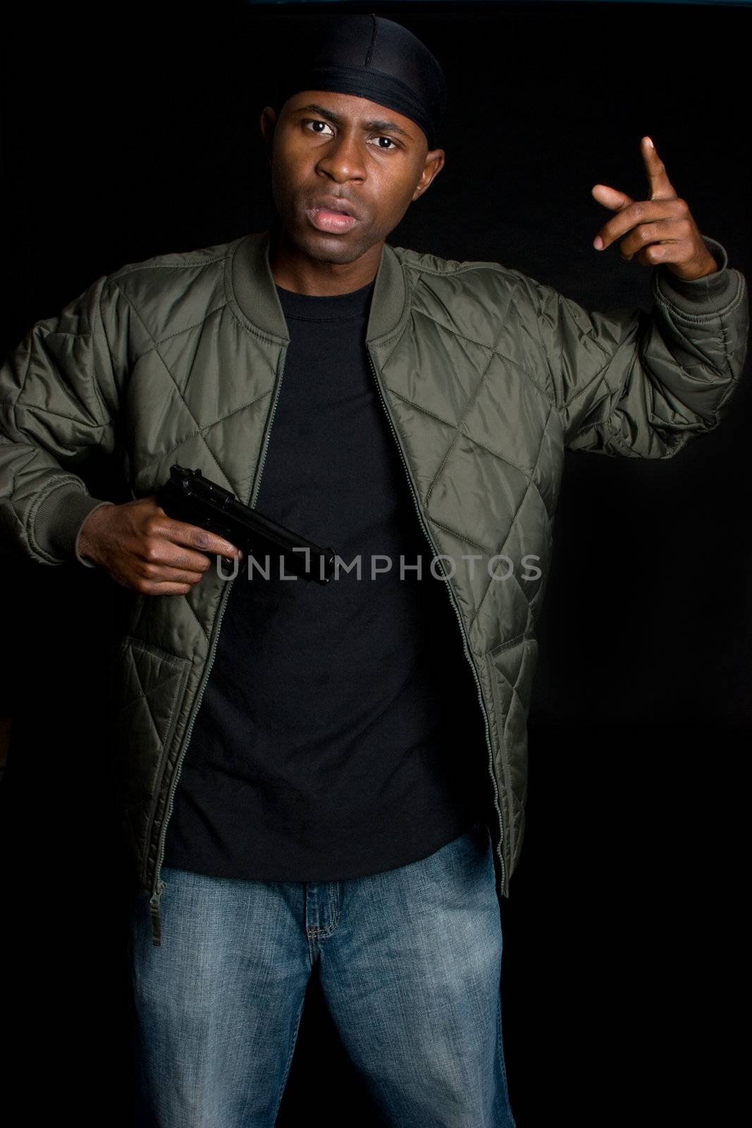 Young black man holding gun