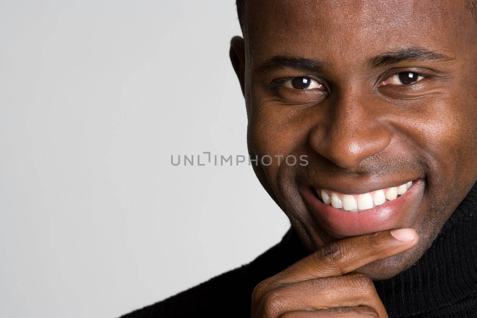 Handsome smiling black man thinking