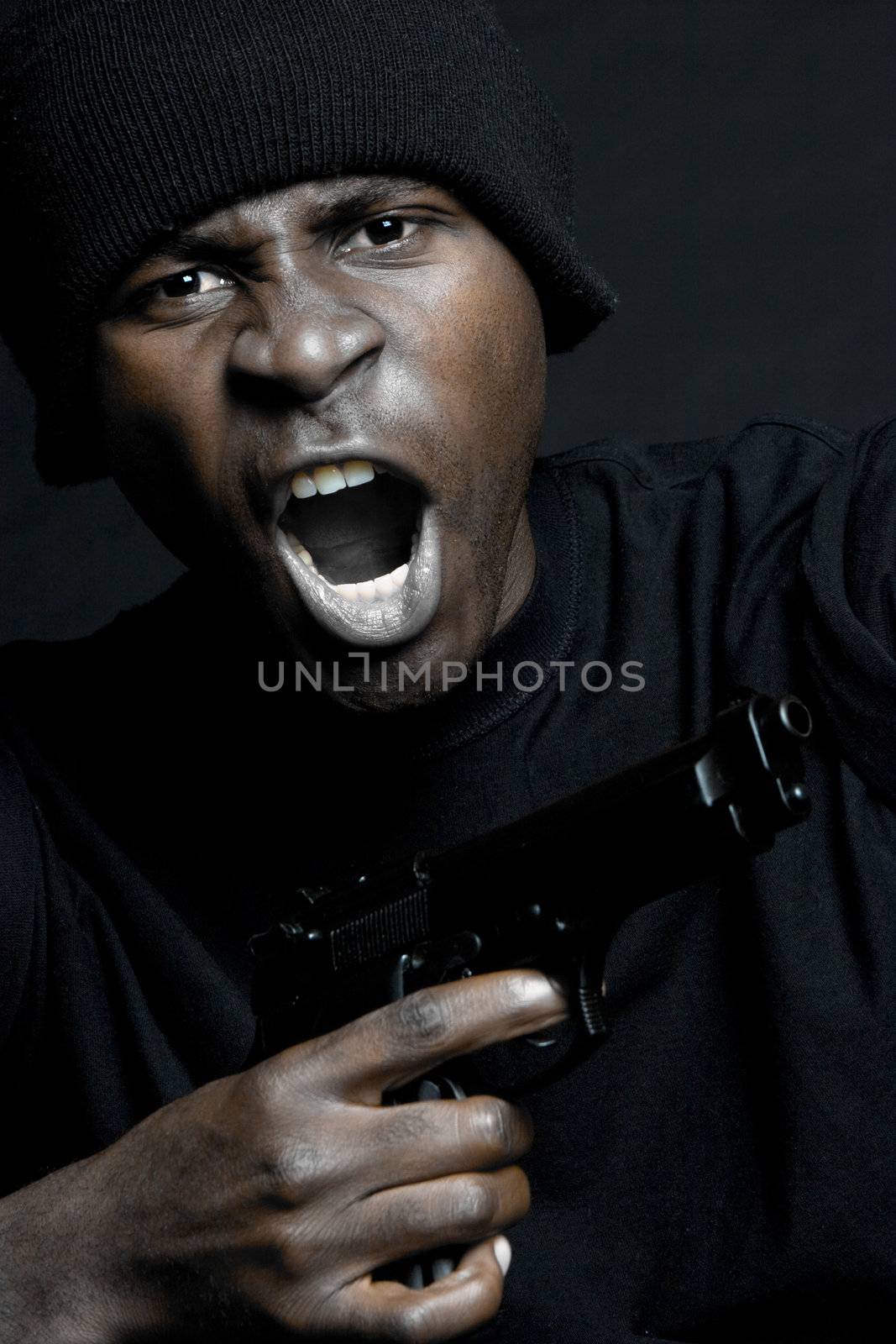 Young black man holding gun