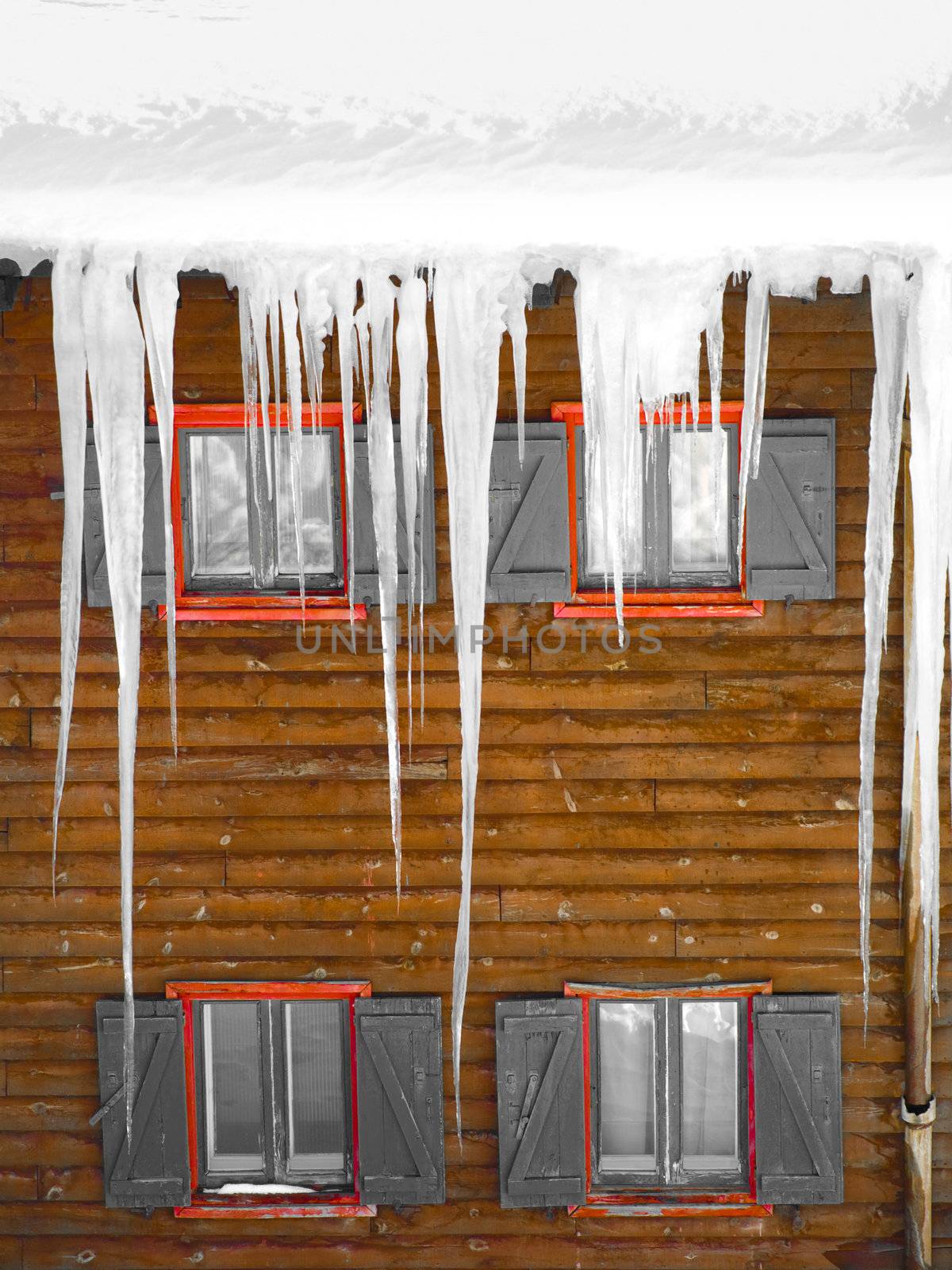Wooden windows with  stalactites of ice