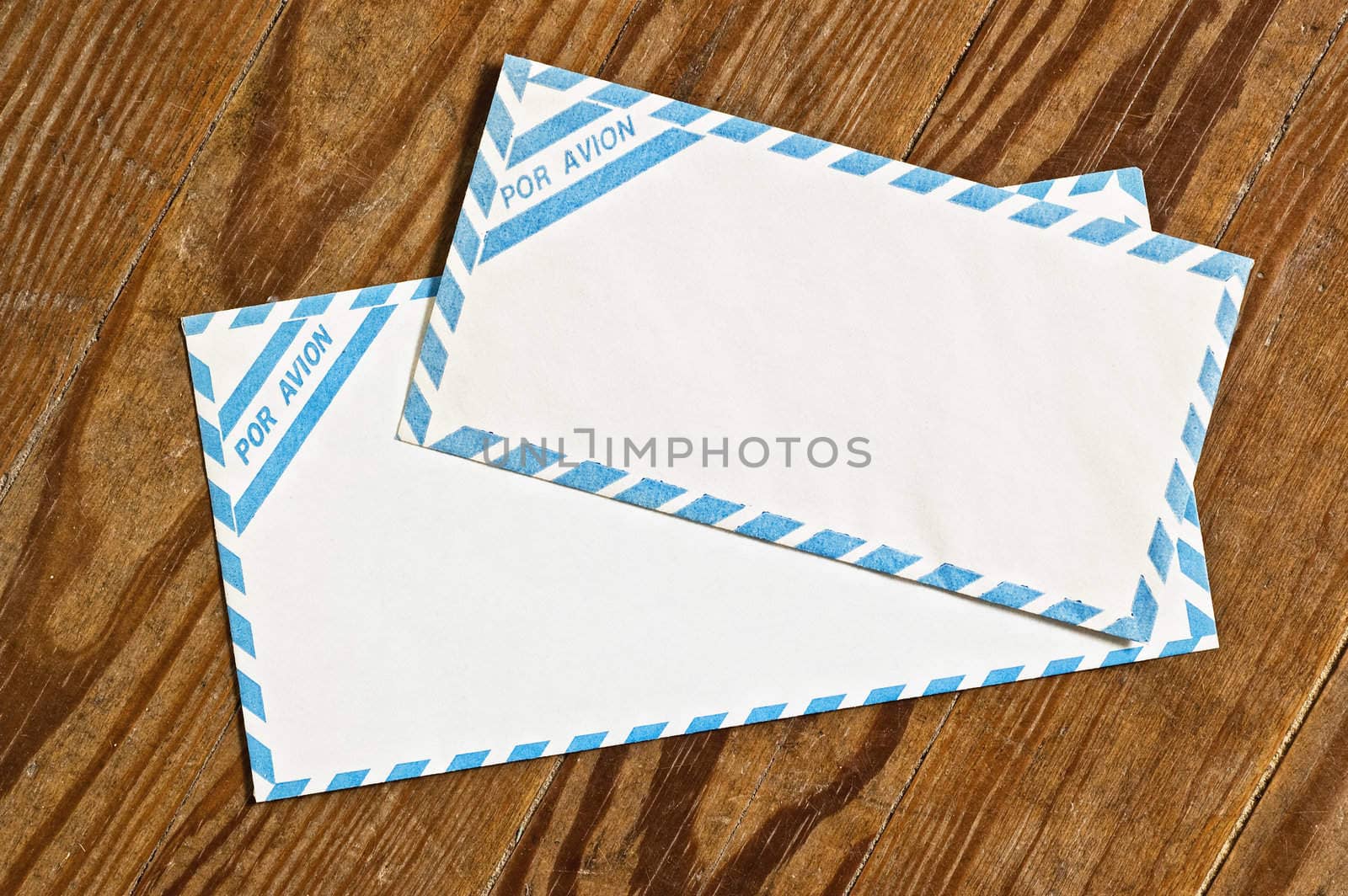 old airmail envelopes over an old wooden table.