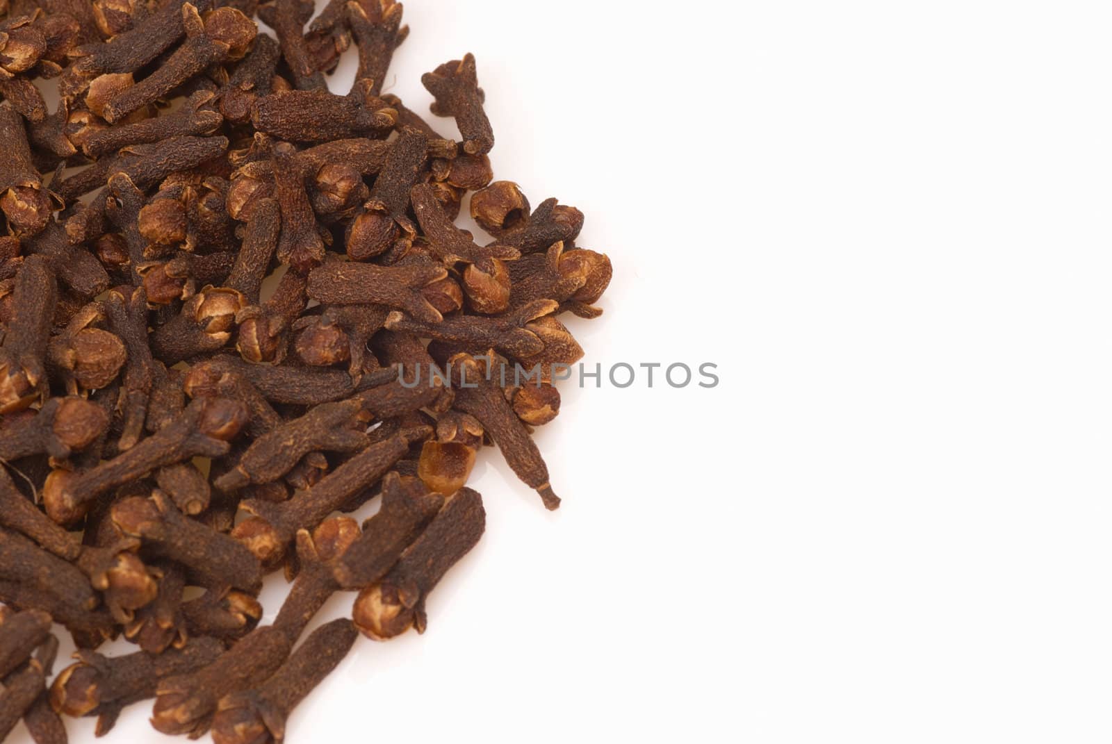 Stack of whole clove buds isolated with copy space