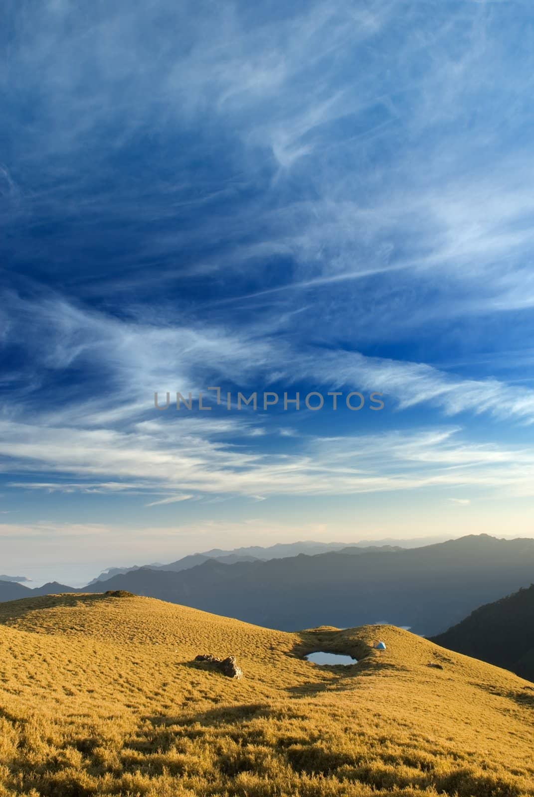 beautiful clouds fly over the grassland in high mountain. by elwynn