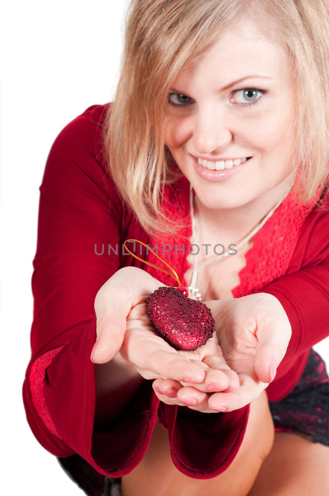 Beautiful woman hands with toy heart isolated on white