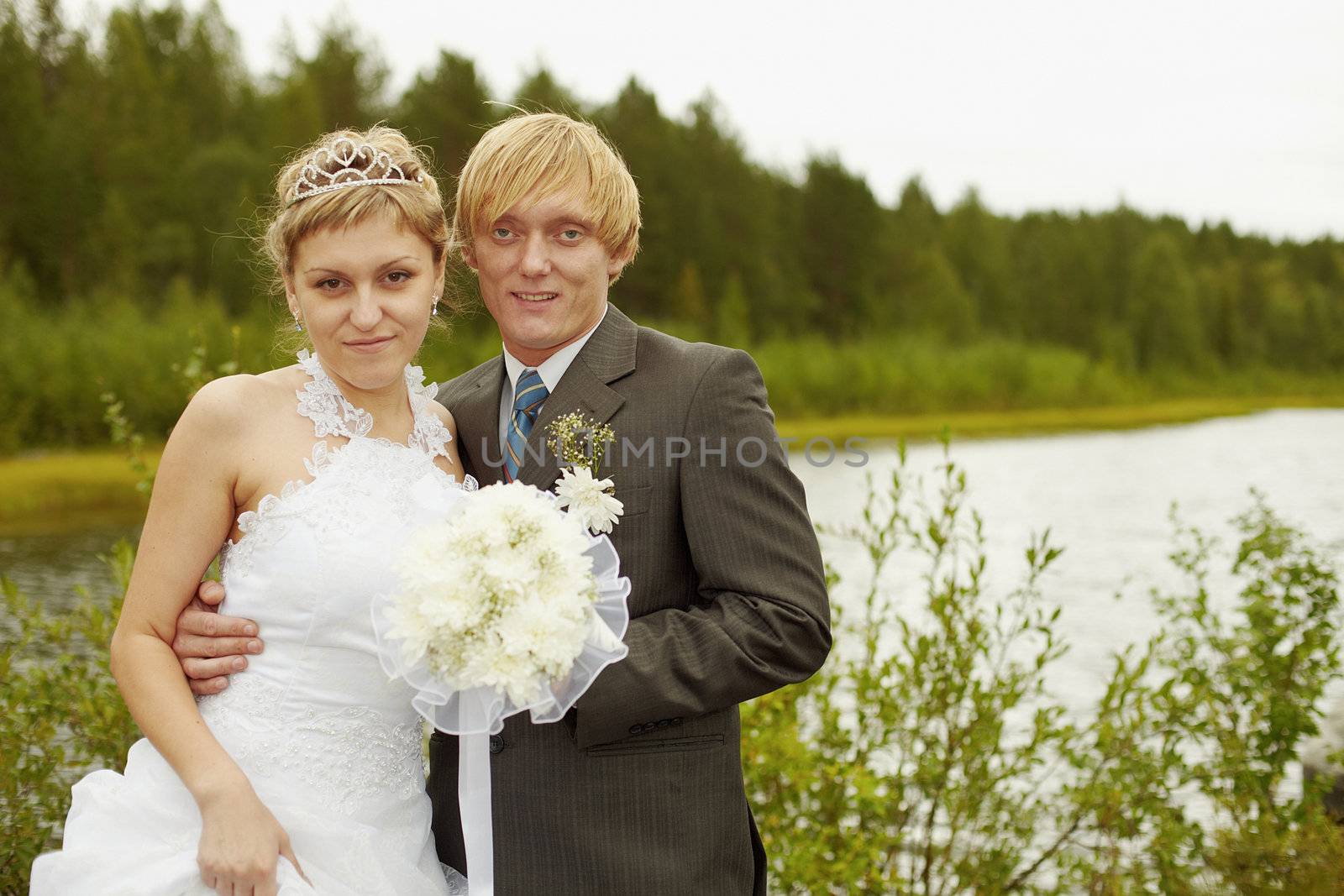 Portrait of newlyweds in an outdoor - summer