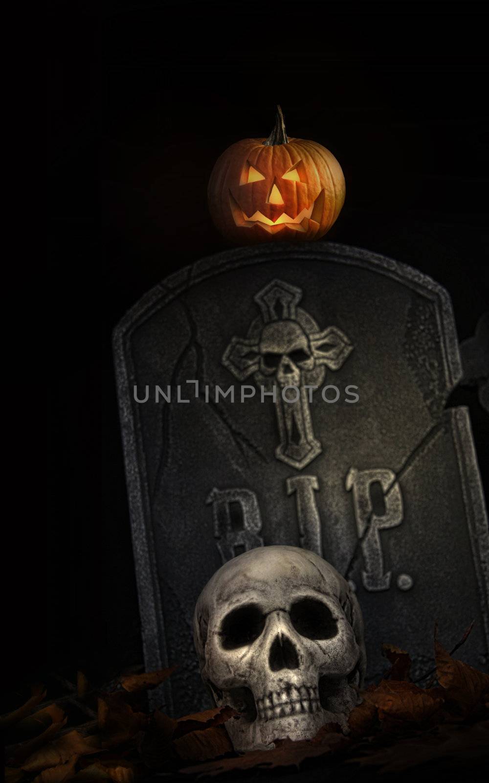 Spooky tombstone with skull and pumpkin on black background