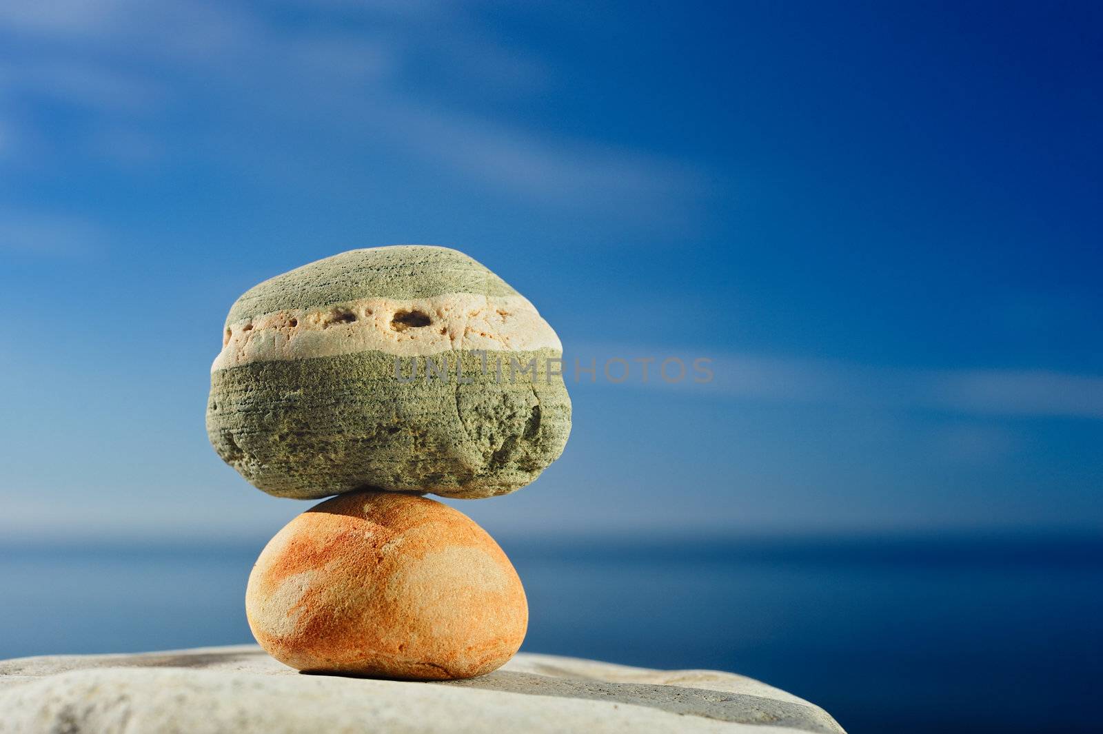 Two stones on a rock sea shore