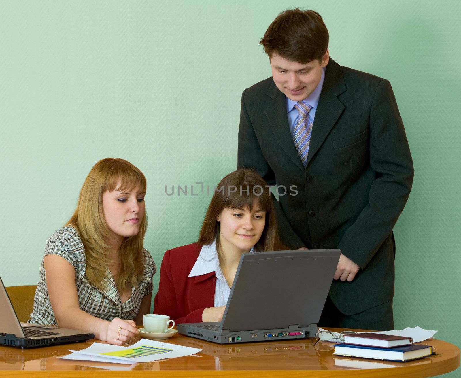 Girls sitting at a desktop and their chief