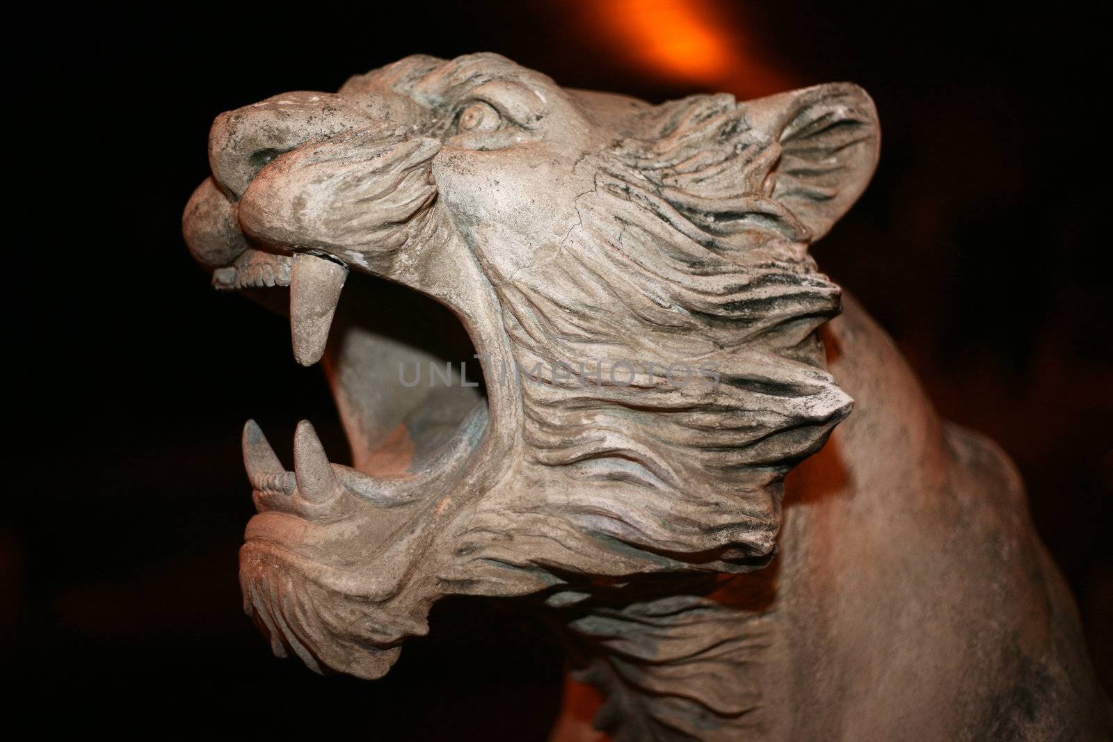 Sculpted head of a lion roaring in horizontal orientation