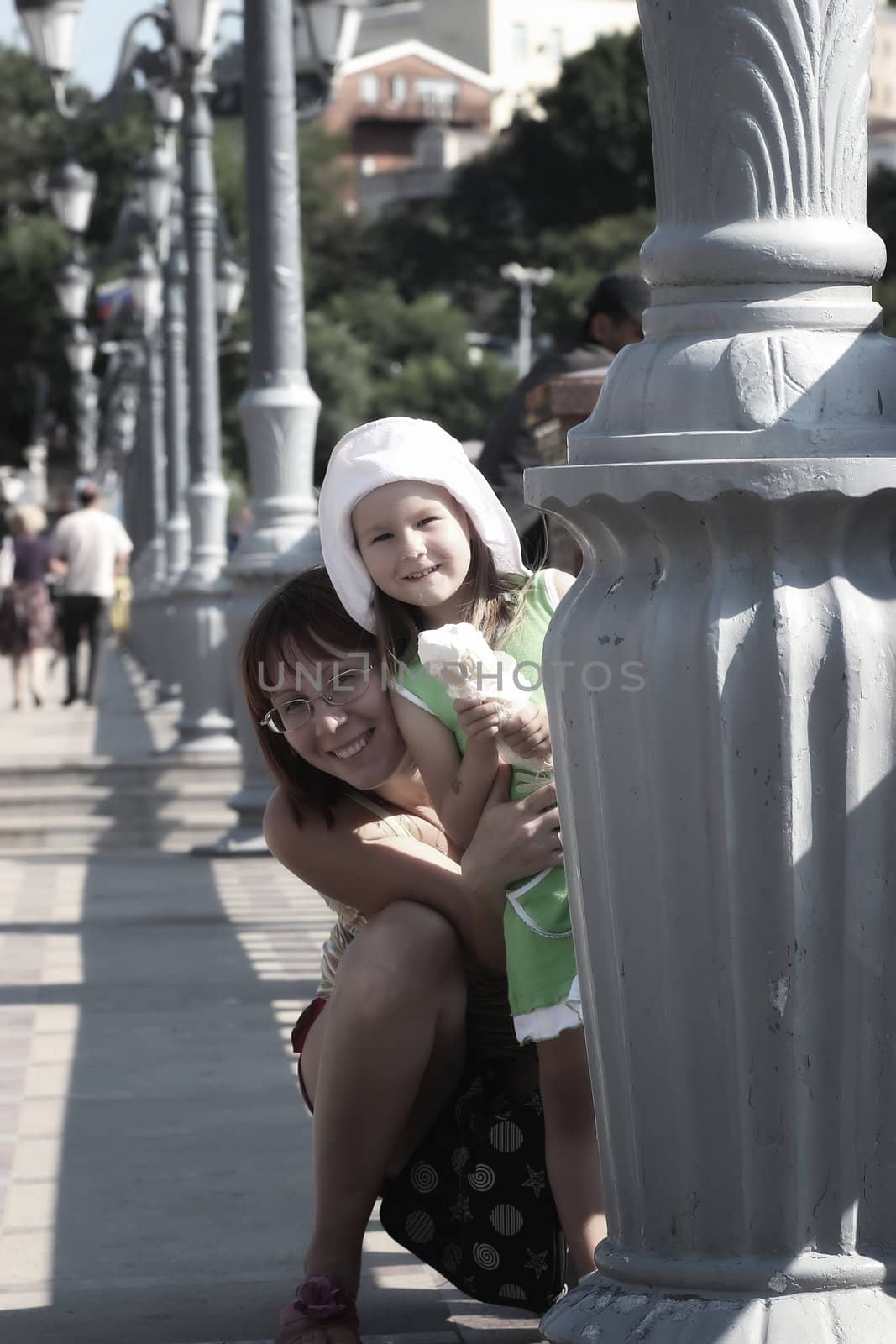 Portrait of mother and child with ice cream in cold colors