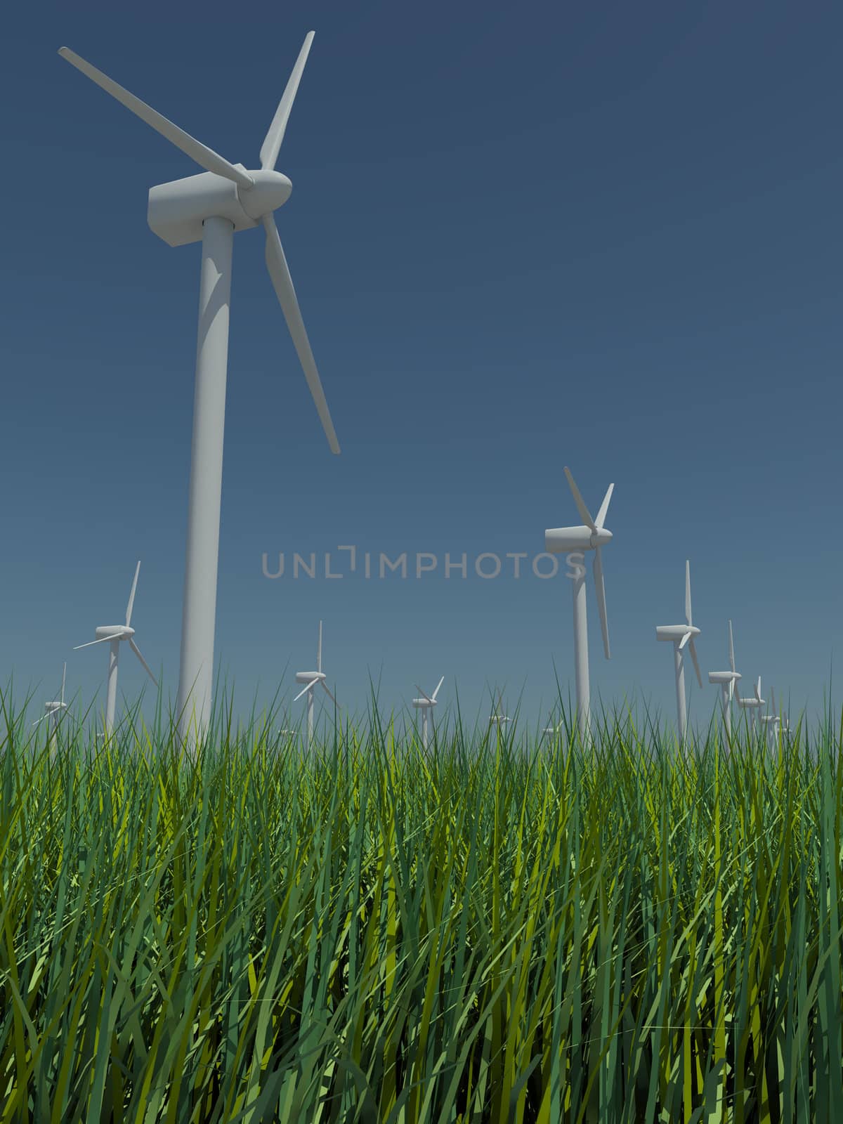 Several windmills standing in the field with grass against the blue sky a bright sunny, windless summer day