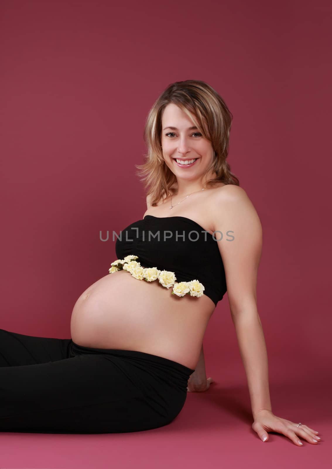 beautiful pregnant woman sitting on the floor