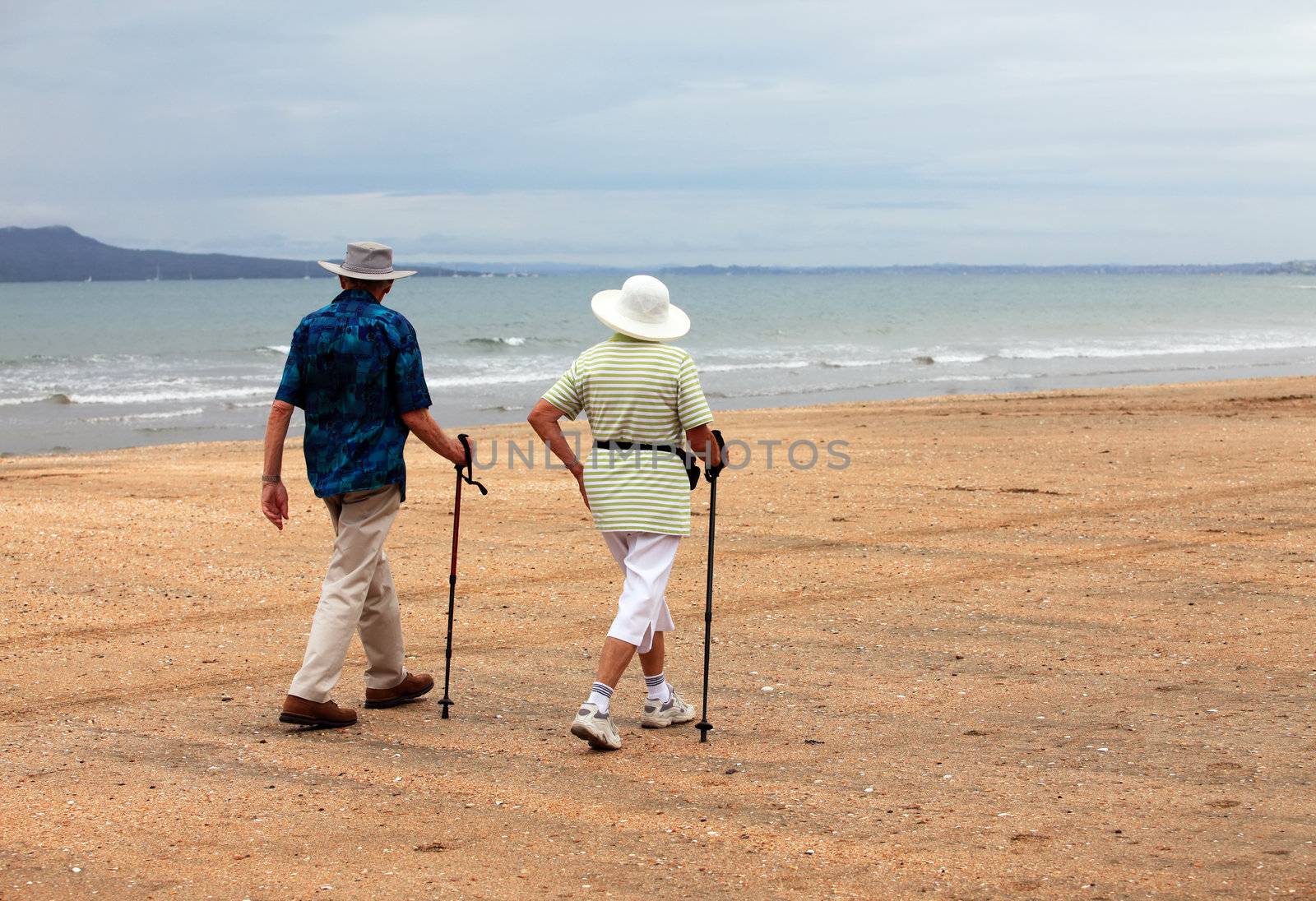 Senior couple on the beach at sunset