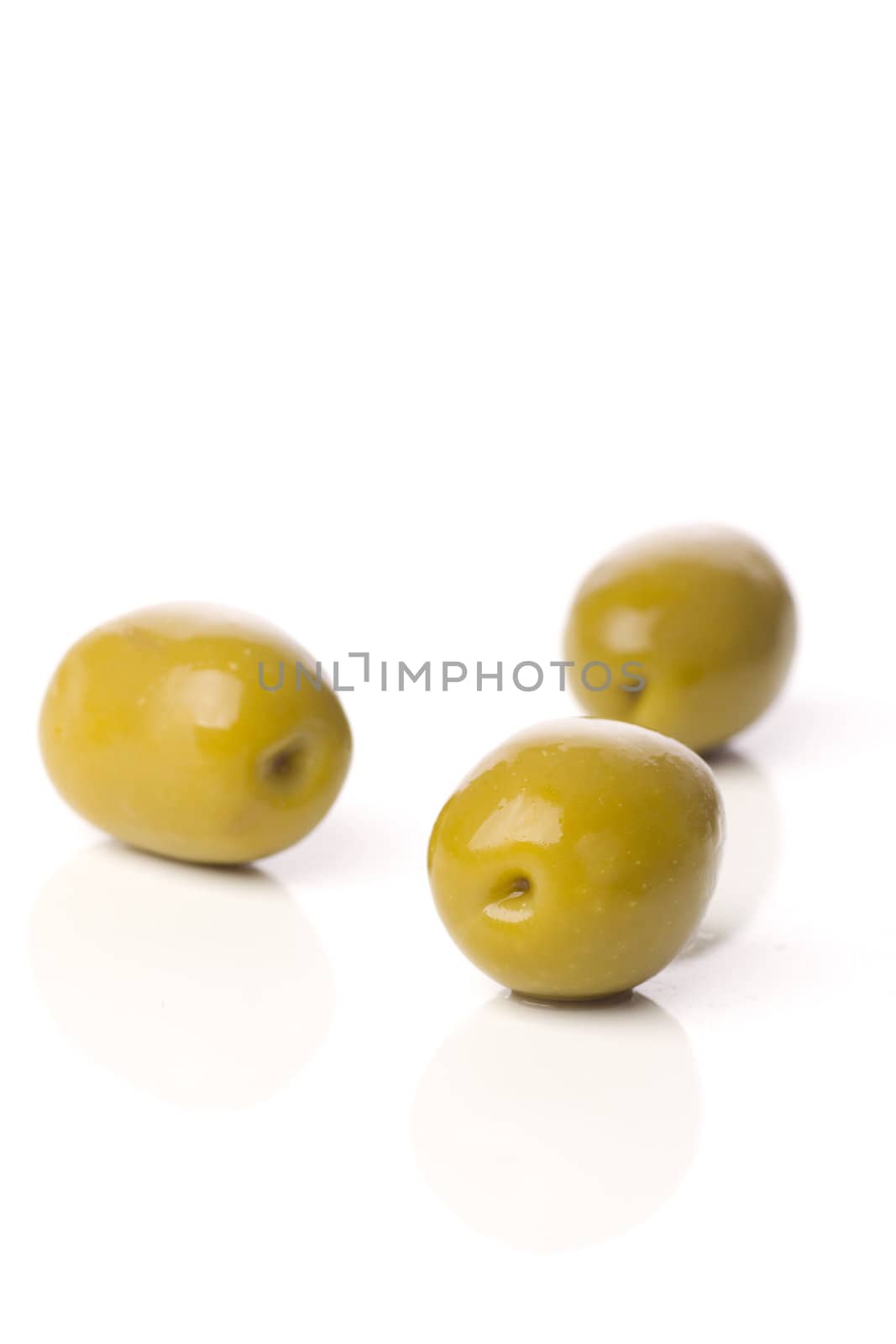 green greek olives on white background - healthy eating