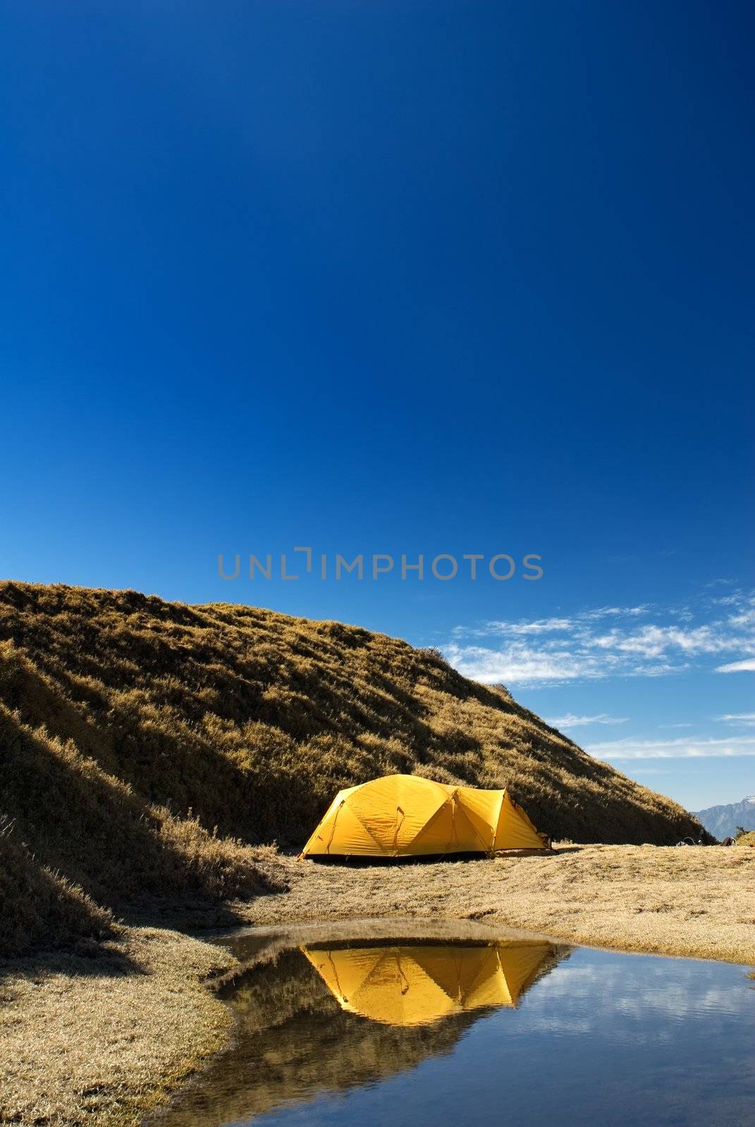 Yellow tent set up near the small pond. by elwynn