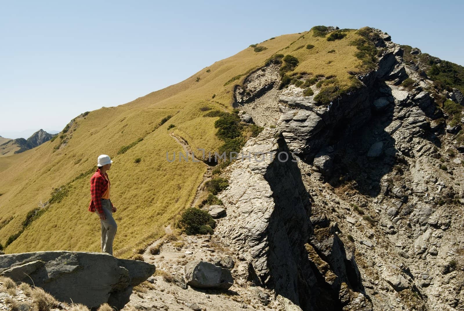 A man watch dangerous rocky ravine in the high mountain.