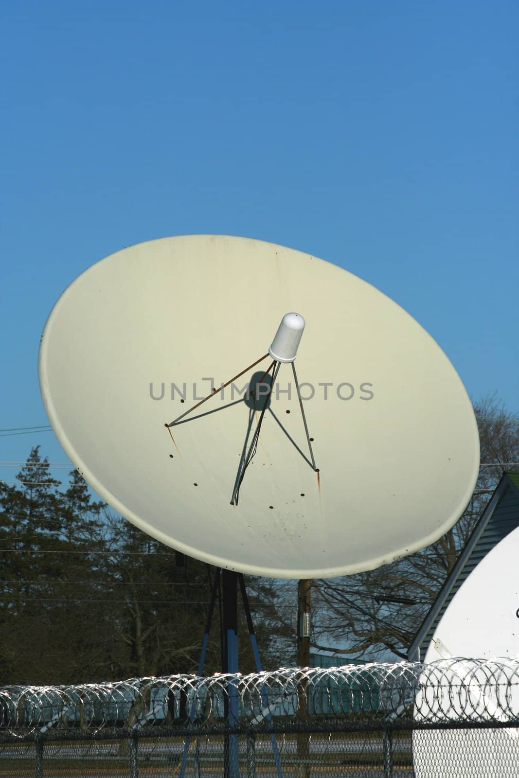 A satellite dish against blue sky