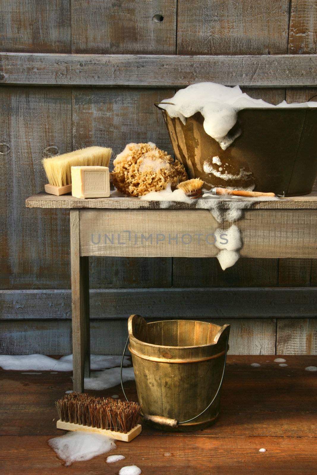 Old wash tub with soap and scrub brushes by Sandralise