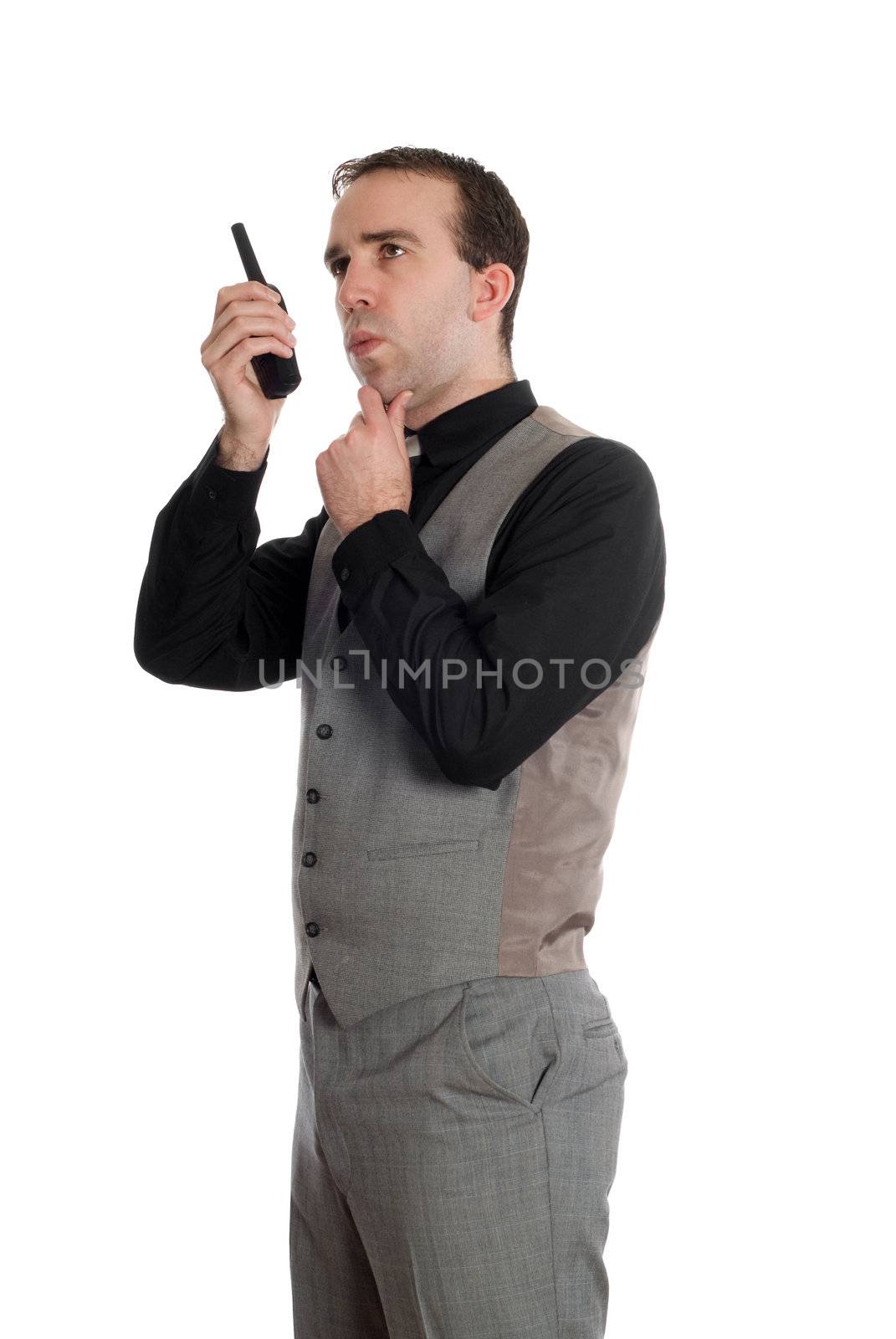 A young businessman wearing a grey suit, talking on a walkie talkie, isolated against a white background