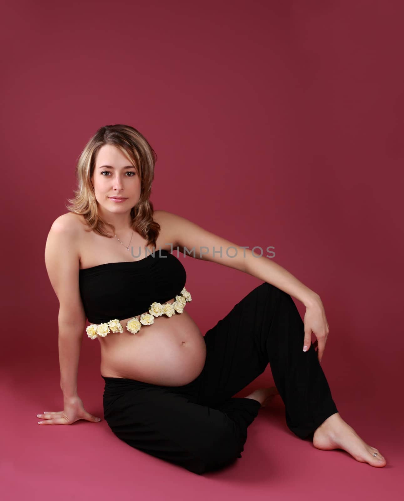 beautiful pregnant woman sitting on the floor