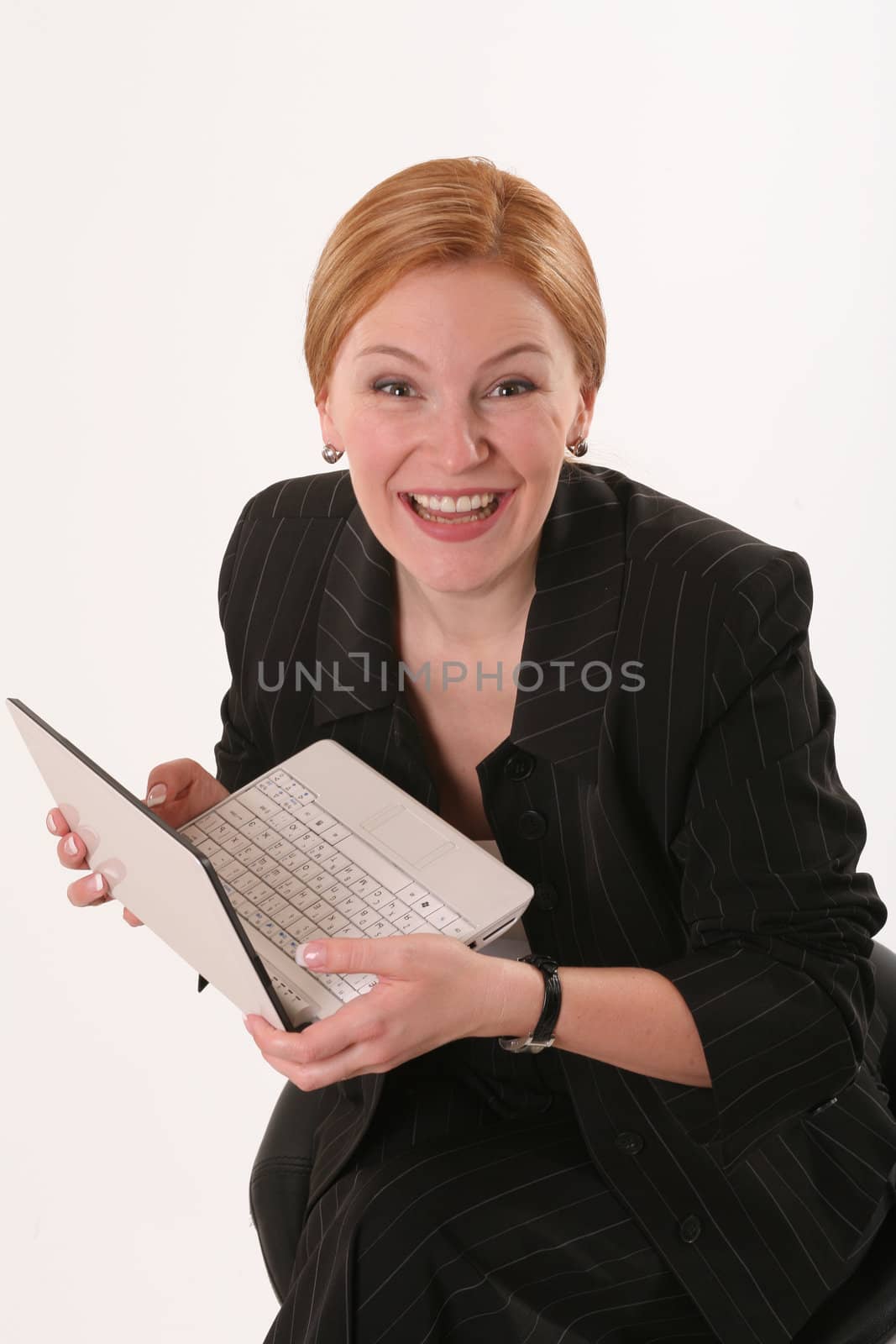 Smiling woman with  notebook on chair