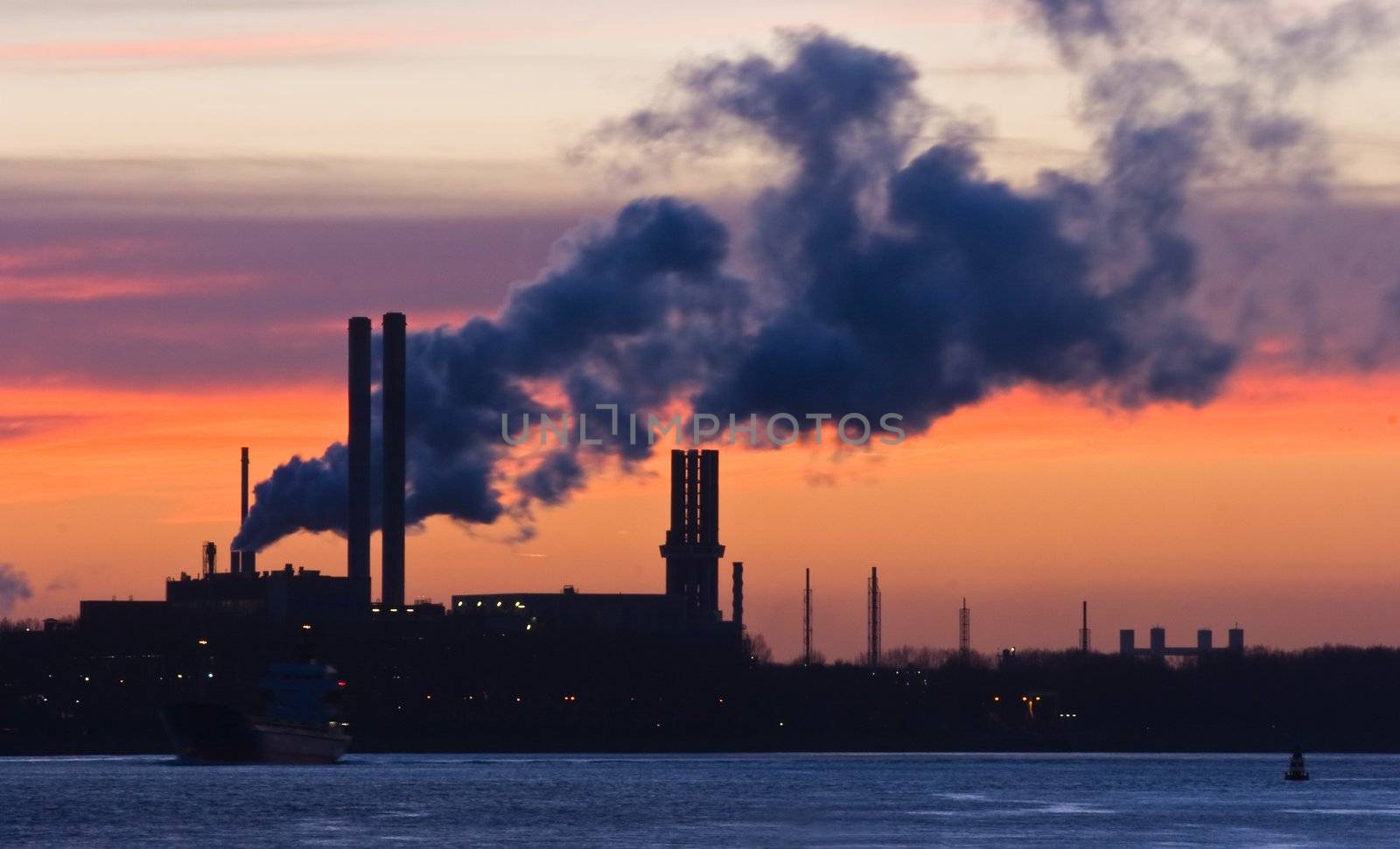 Silhouette of industry and industrial pollution after sunset on winter evening