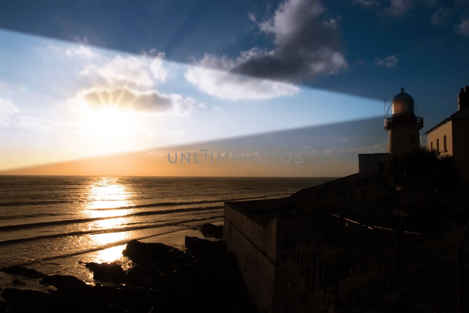 lighthouse captured with the sun behind it and beams on