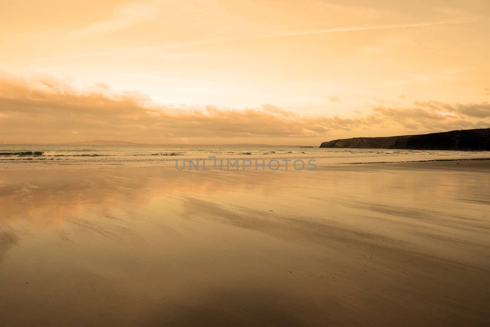 the waves with reflection crashing in on ballybunion beach ireland