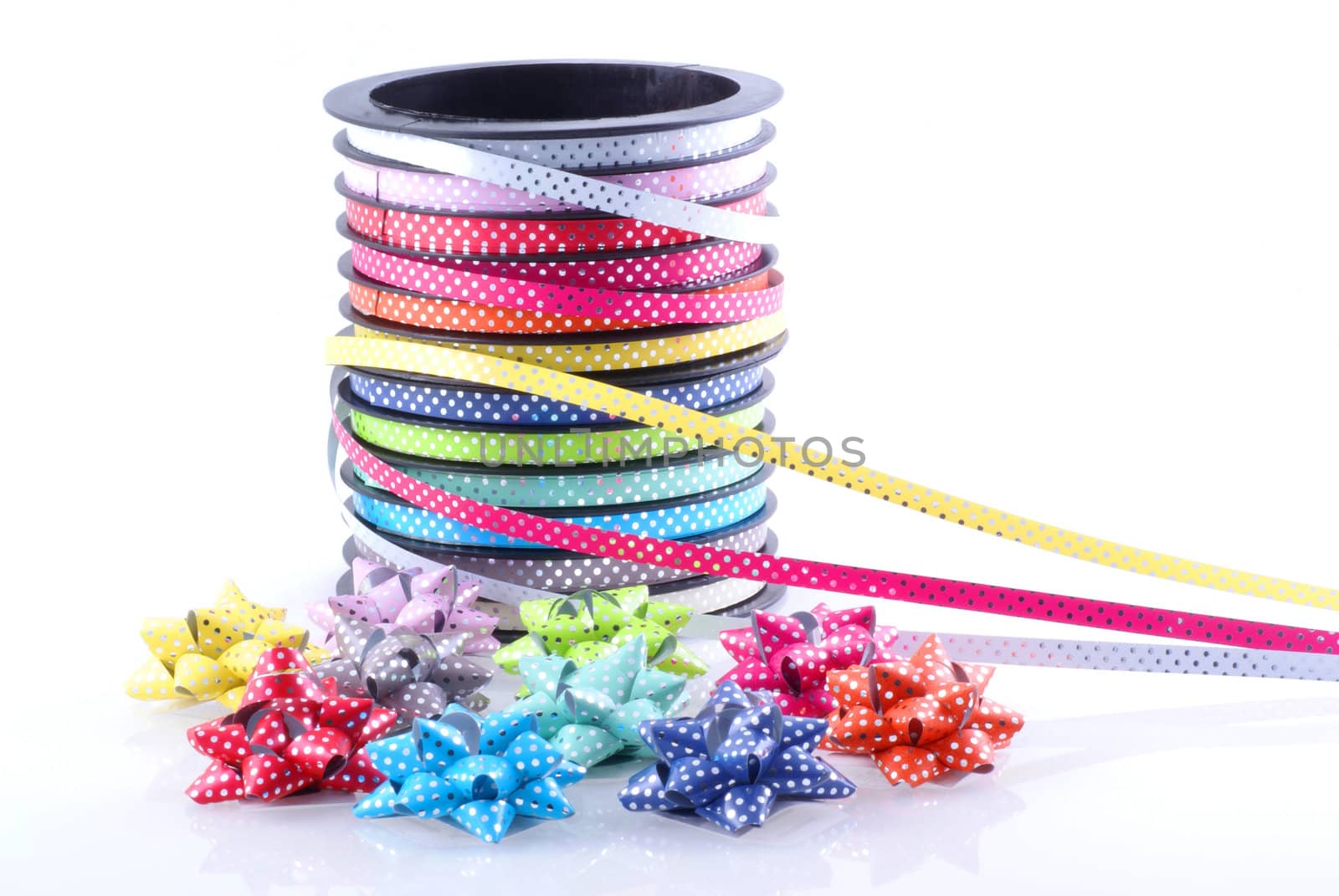 Different kinds of decoration ribbon with a bunch of bows isolated on white.