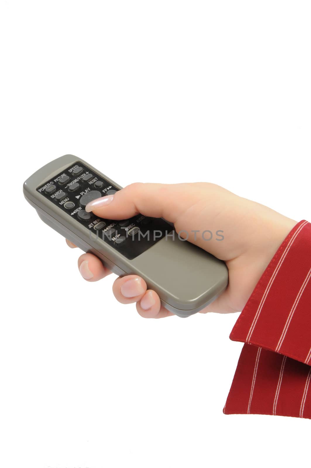 womanish hand holds remote control unit by dyoma