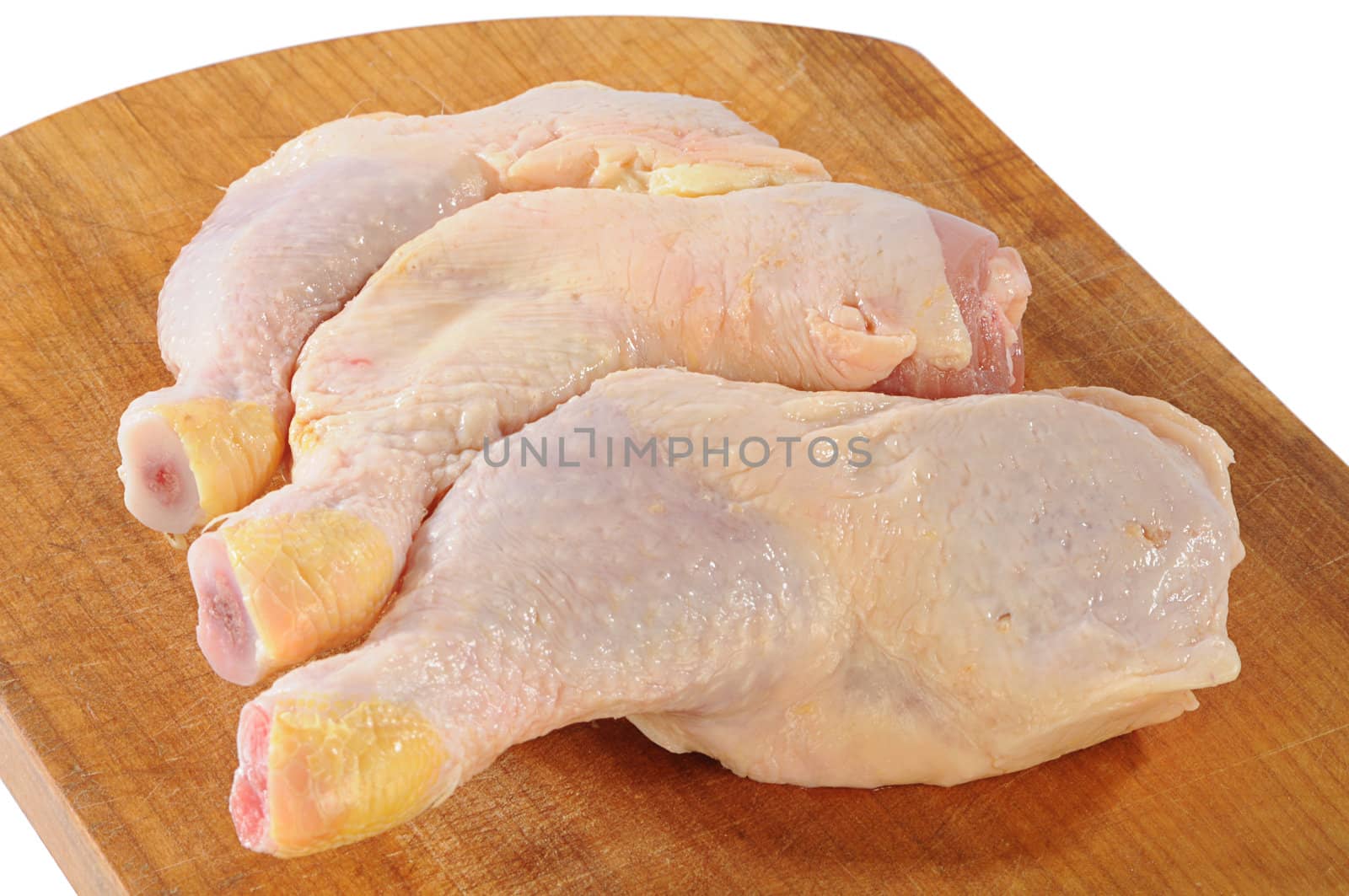 fresh chicken legs on the wood plate