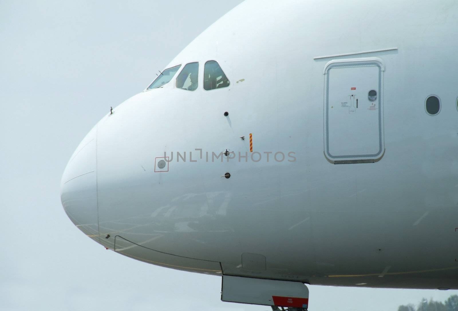 Nose of very big, wide-body airliner on the ground