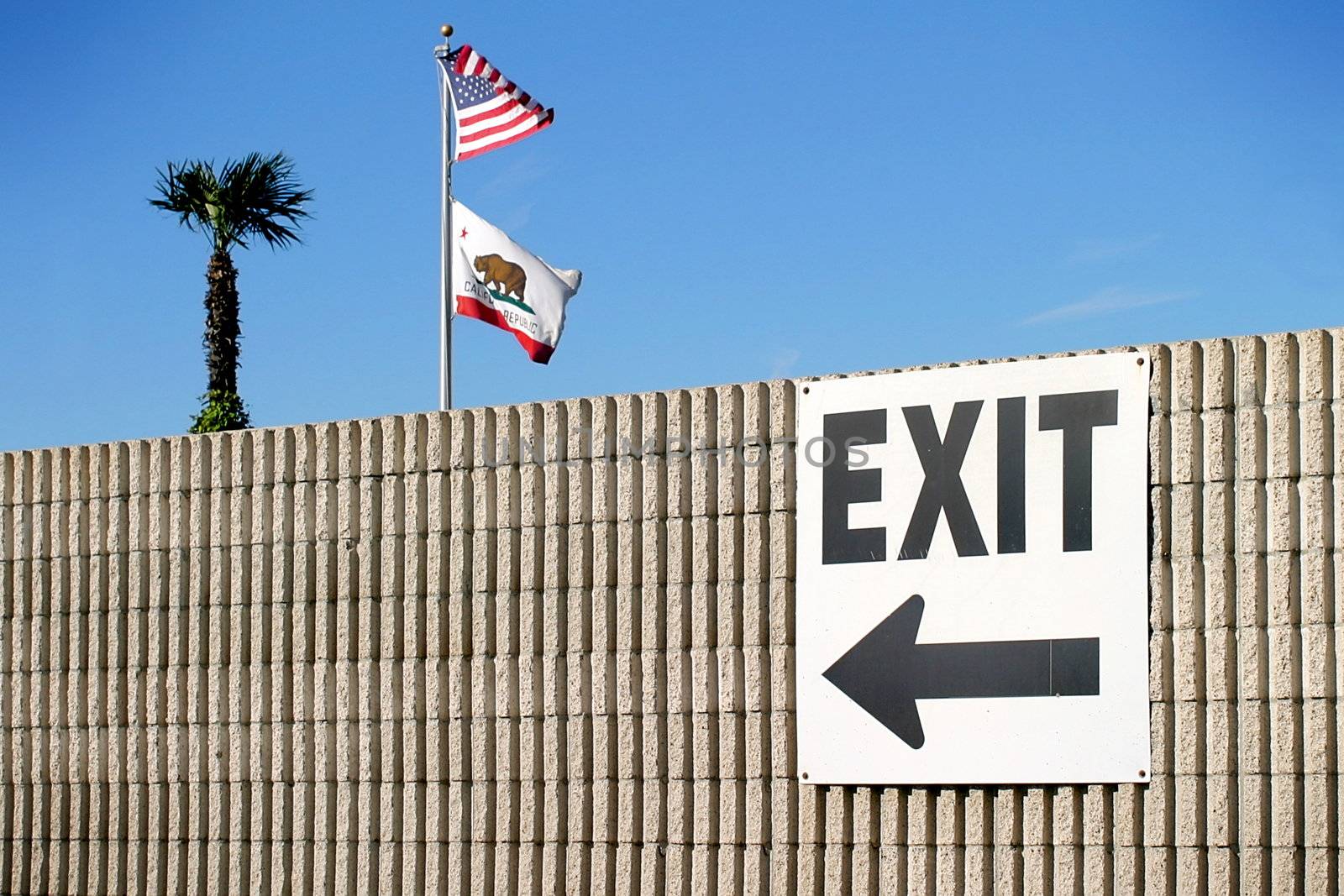 exit sign with the usa and california flag and a palm tree