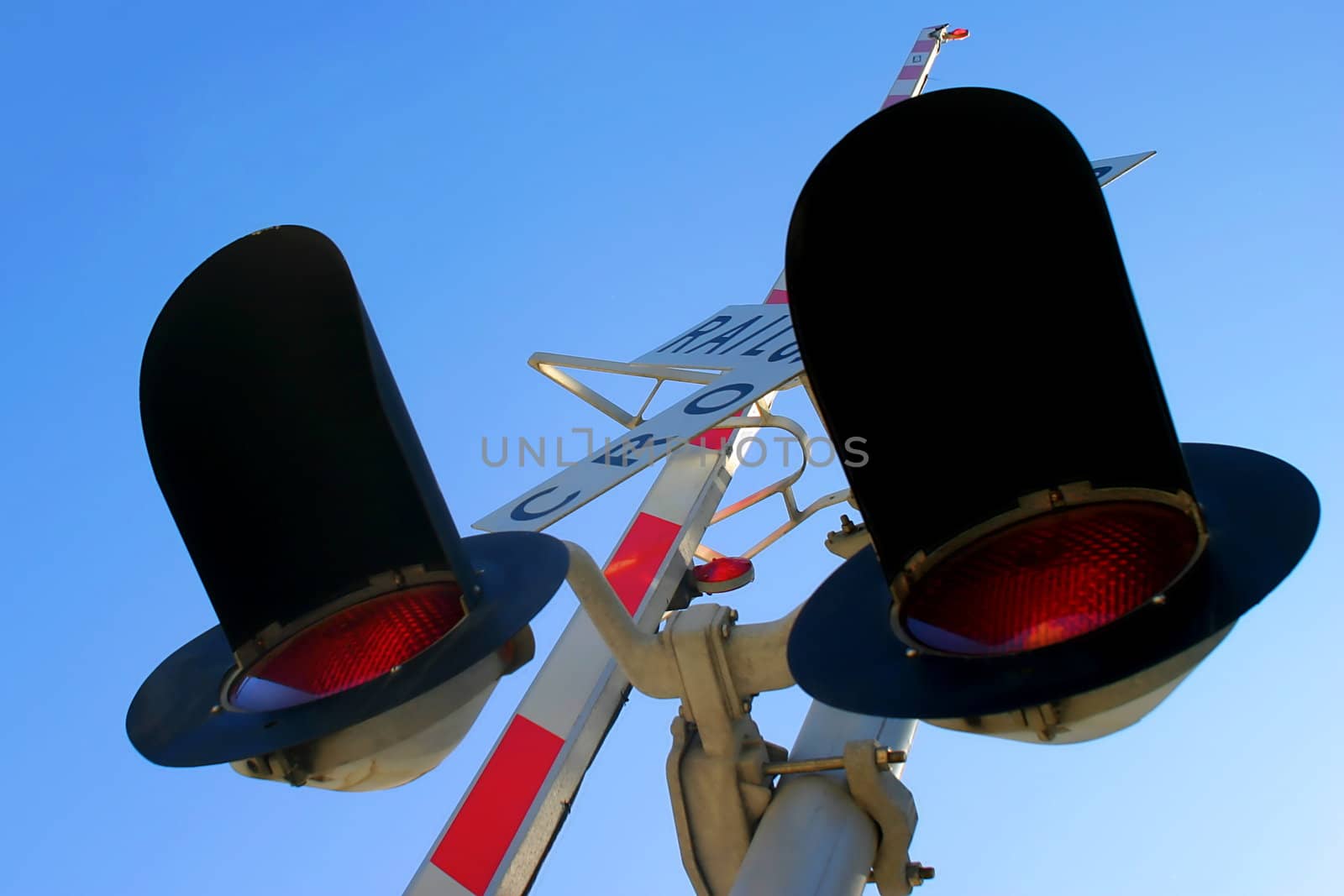 Railroad Crossing signal from below with sky in the background