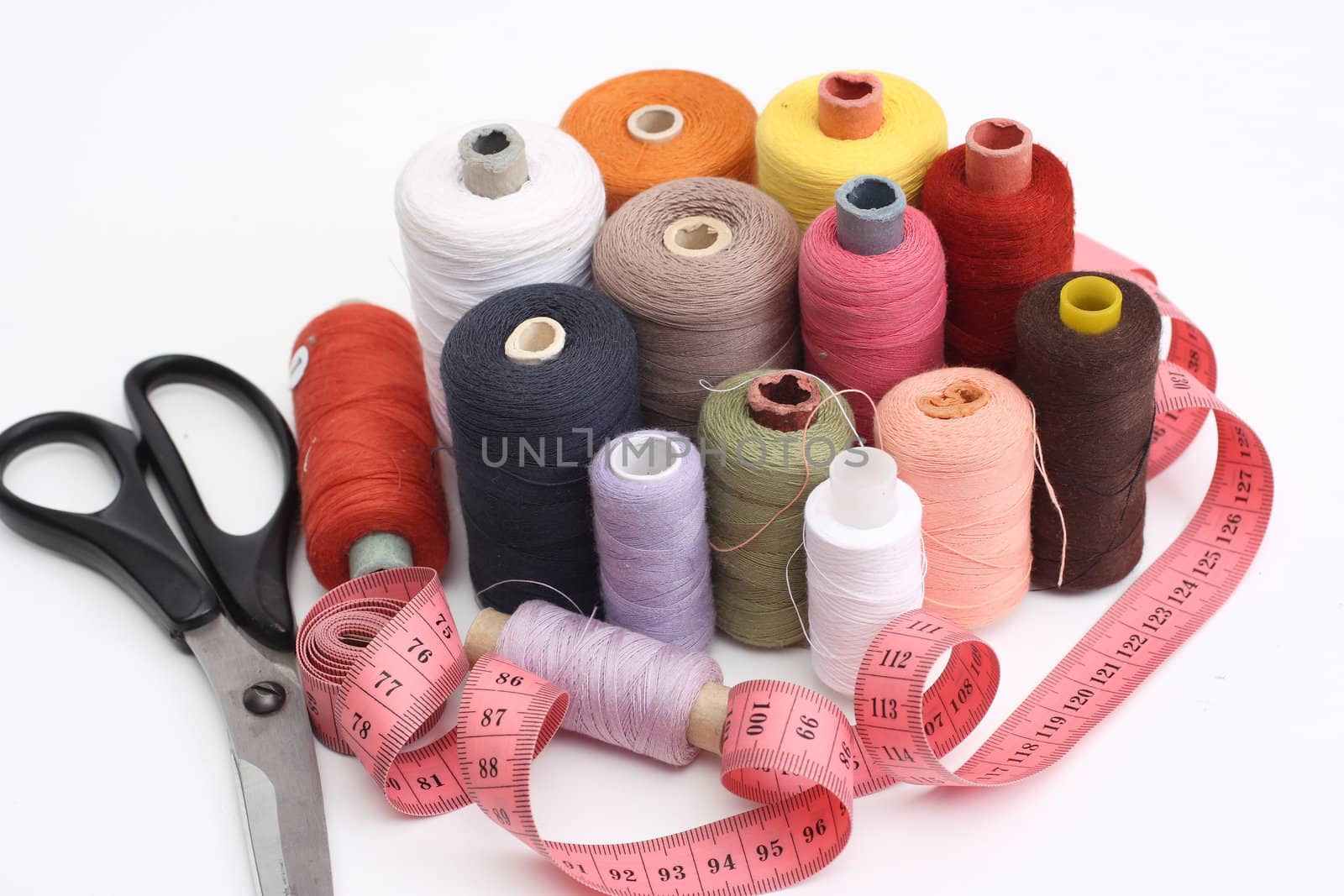 set of a color thread, scissors and tape measure