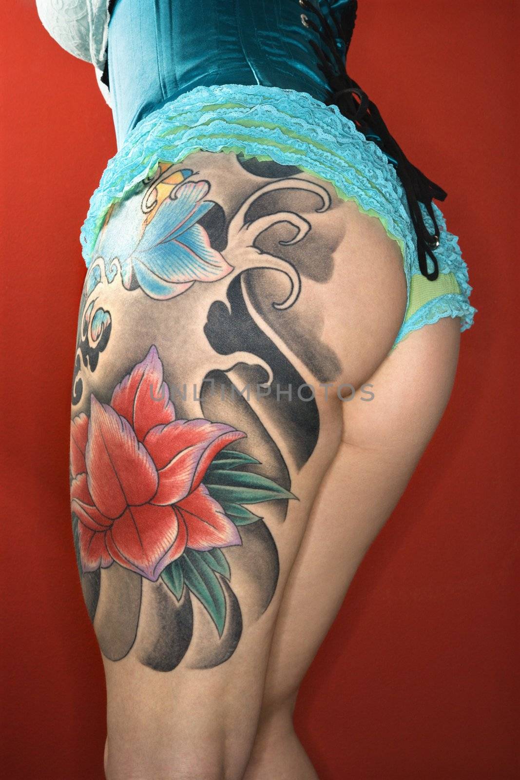Close-up of womans tattooed leg.