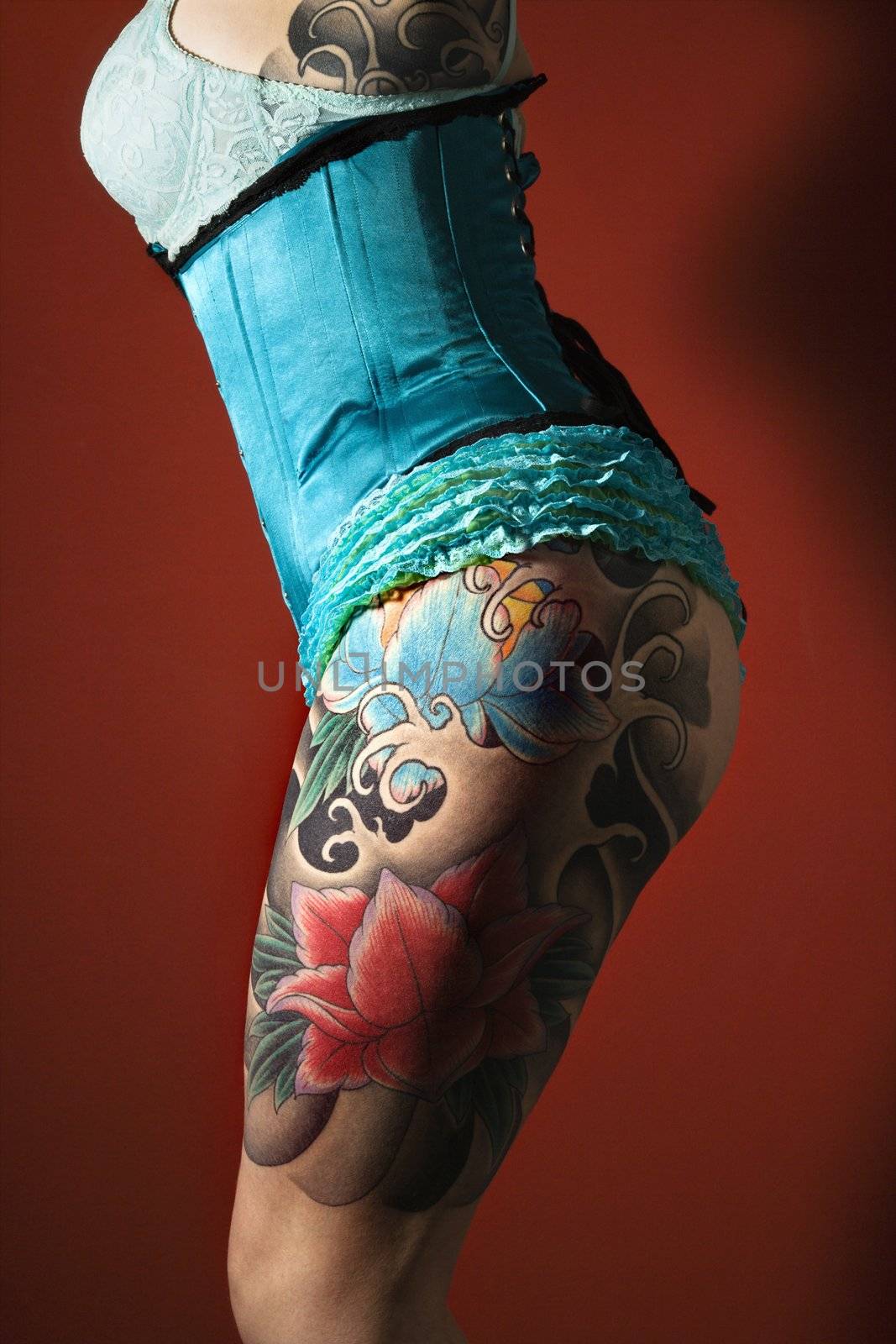 Tattooed womans leg by iofoto