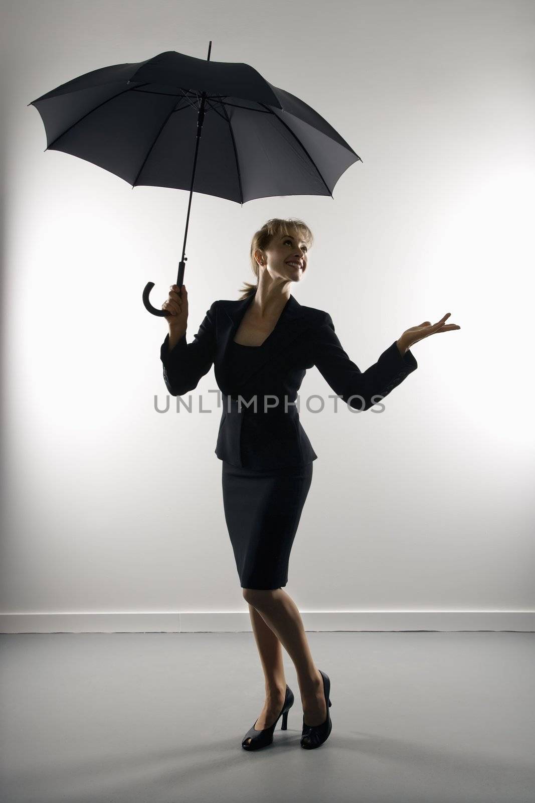 Businesswoman with umbrella. by iofoto