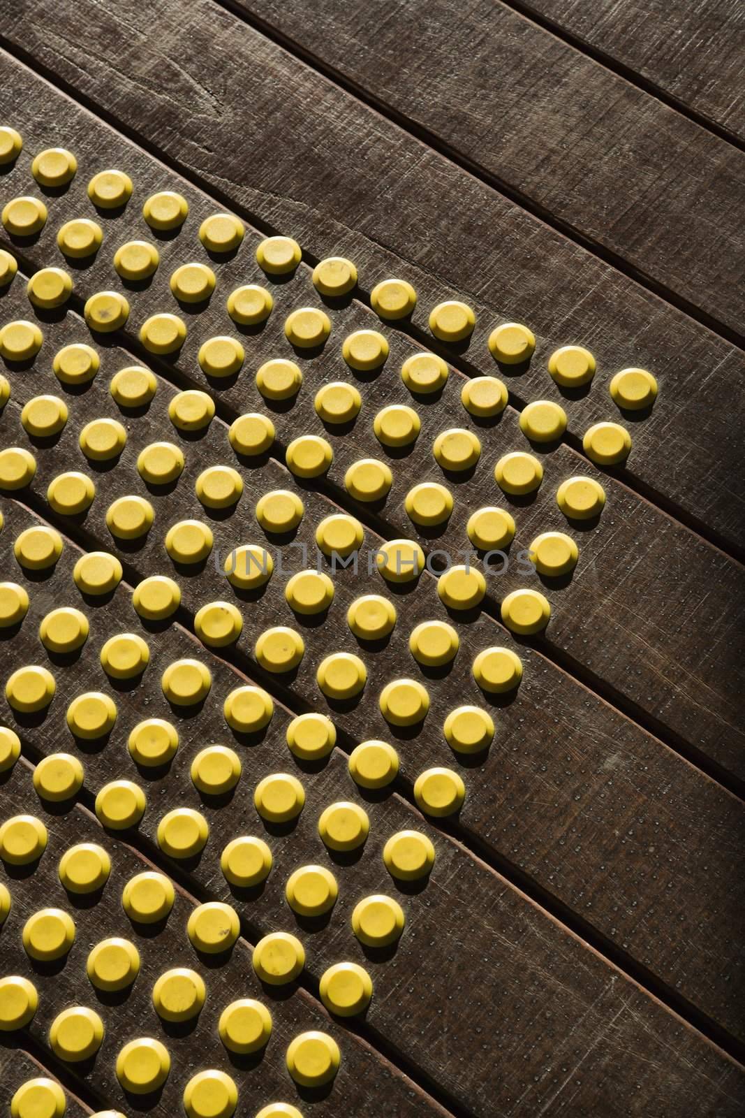 Yellow dot pattern on wooden flooring.