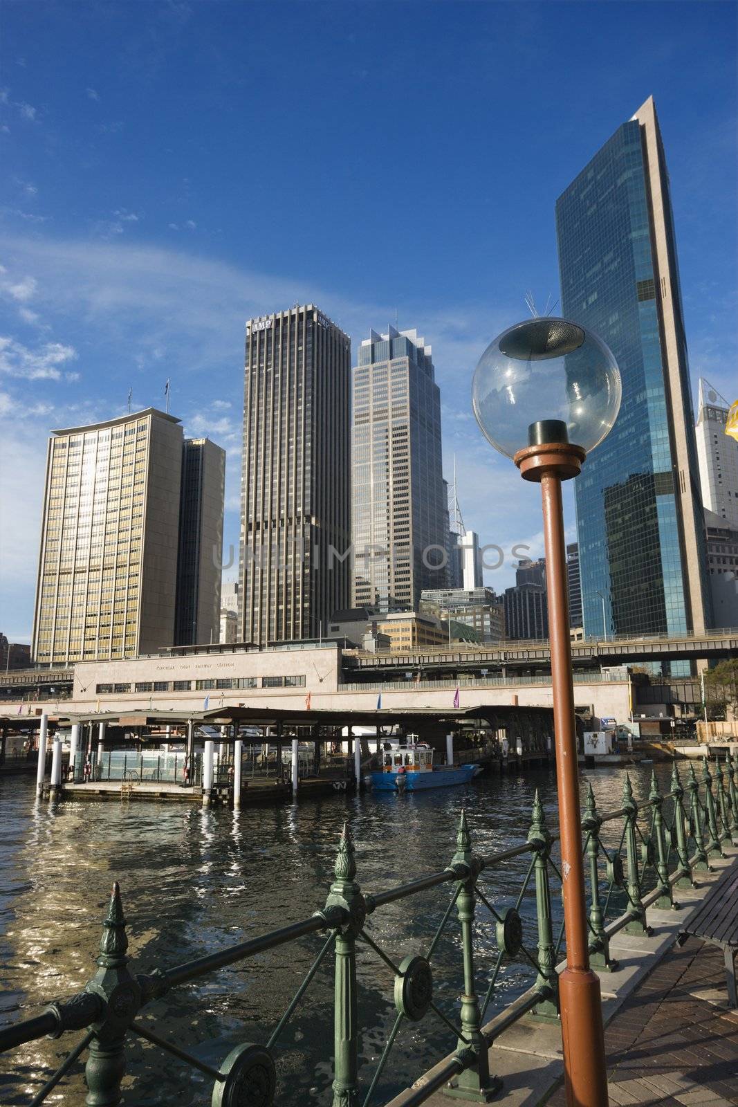 Circular Quay Railway Station in Sydney Cove with view of downtown skyscrapers and lammpost in Sydney, Australia.