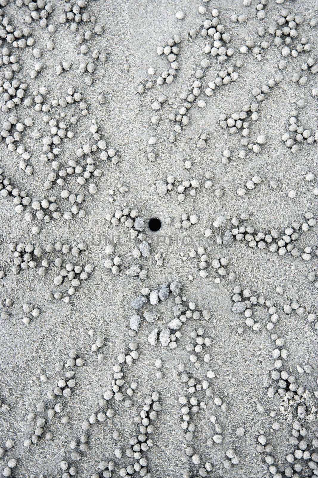 Stones and hole in sand. by iofoto
