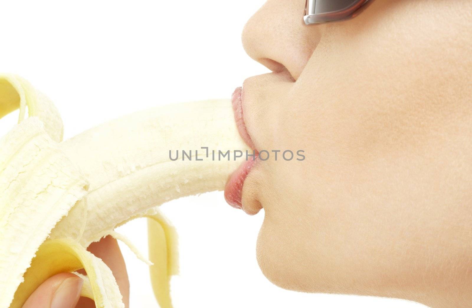 closeup picture of woman eating ripe banana