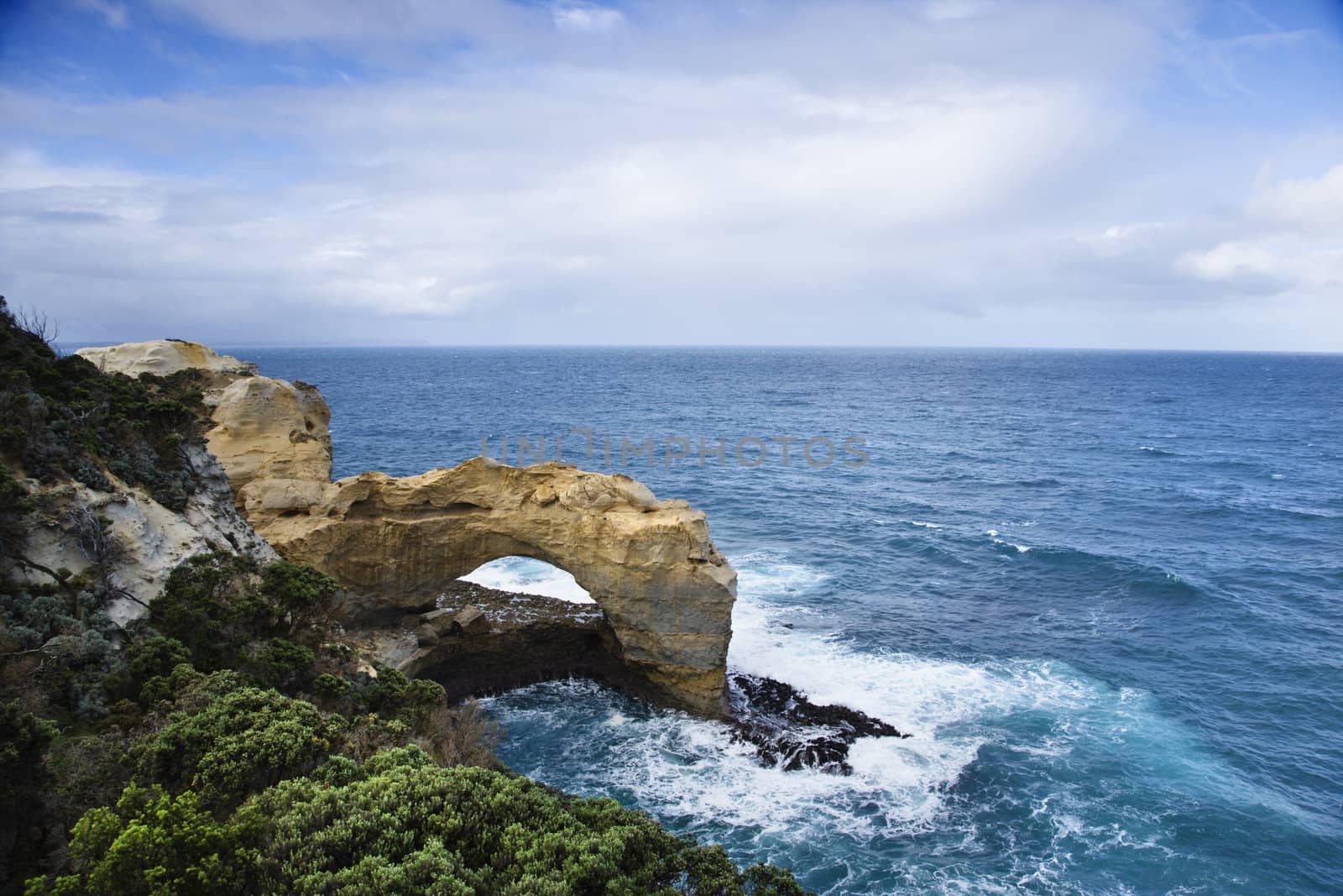 Rock arch in ocean. by iofoto